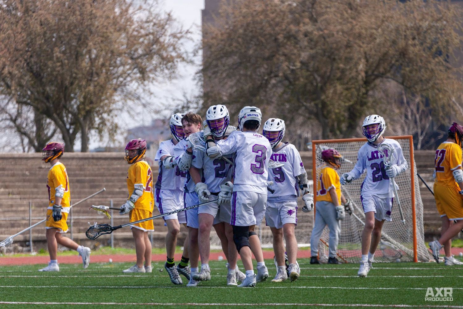 The lacrosse players celebrate with their teammates