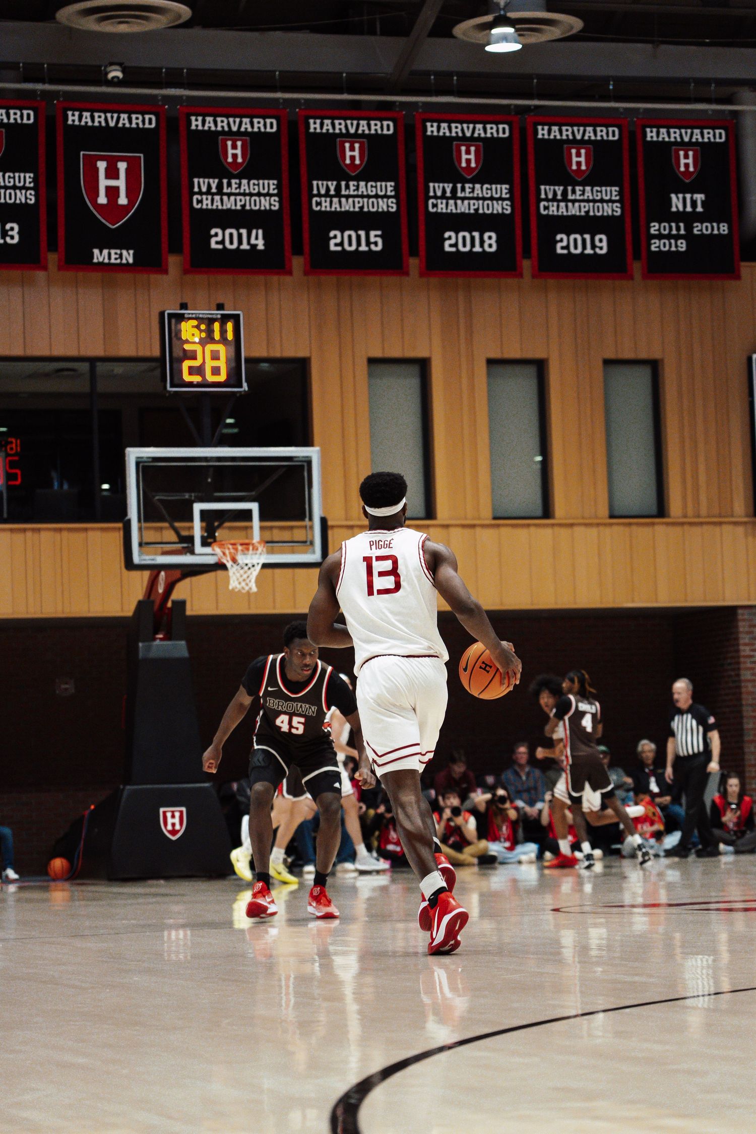 A basketball player dribbles the ball down the court.