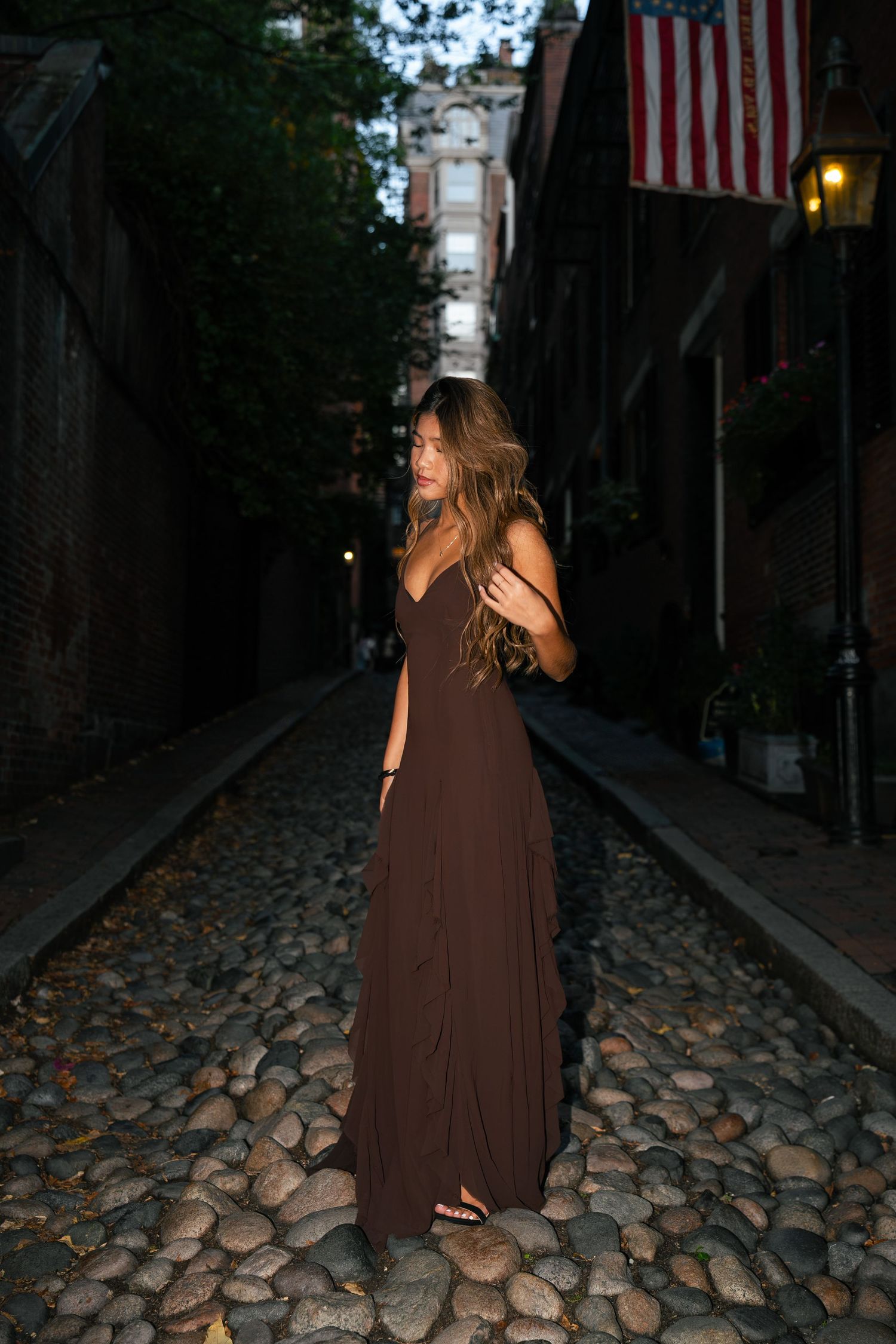 A girl adjusts her hair on Acorn Street