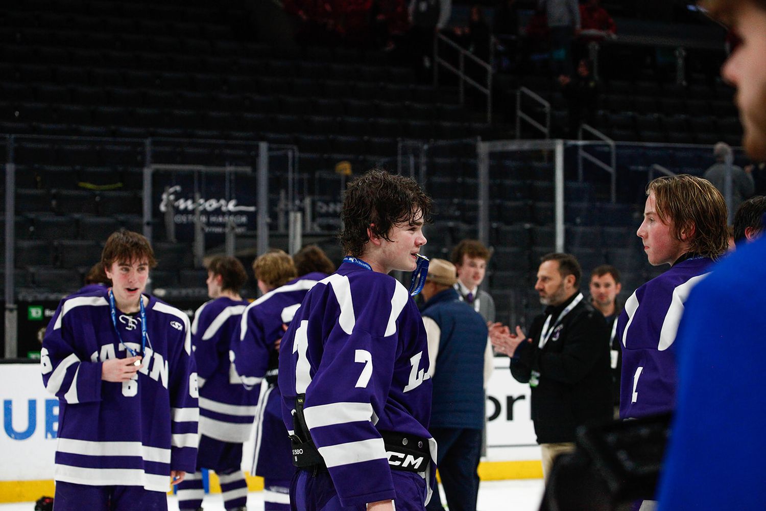 A hockey player bits his medal post-win.