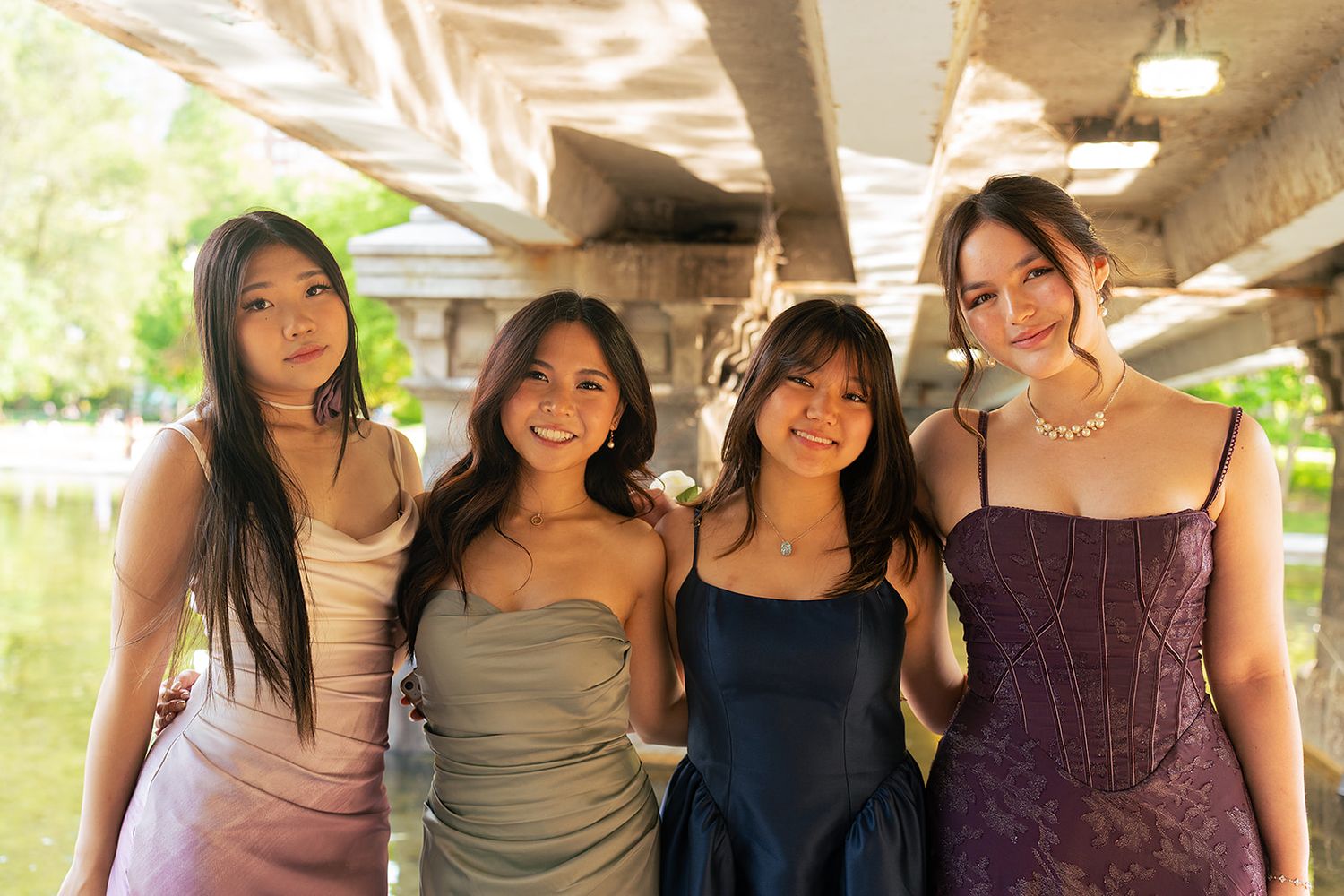 A group of girls pose under the bridge at Boston Public Garden