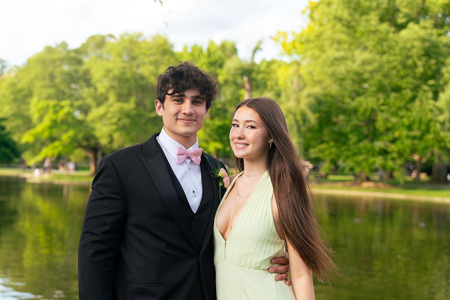 A prom couple poses in front of the Swan Pond at Boston Public Garden.