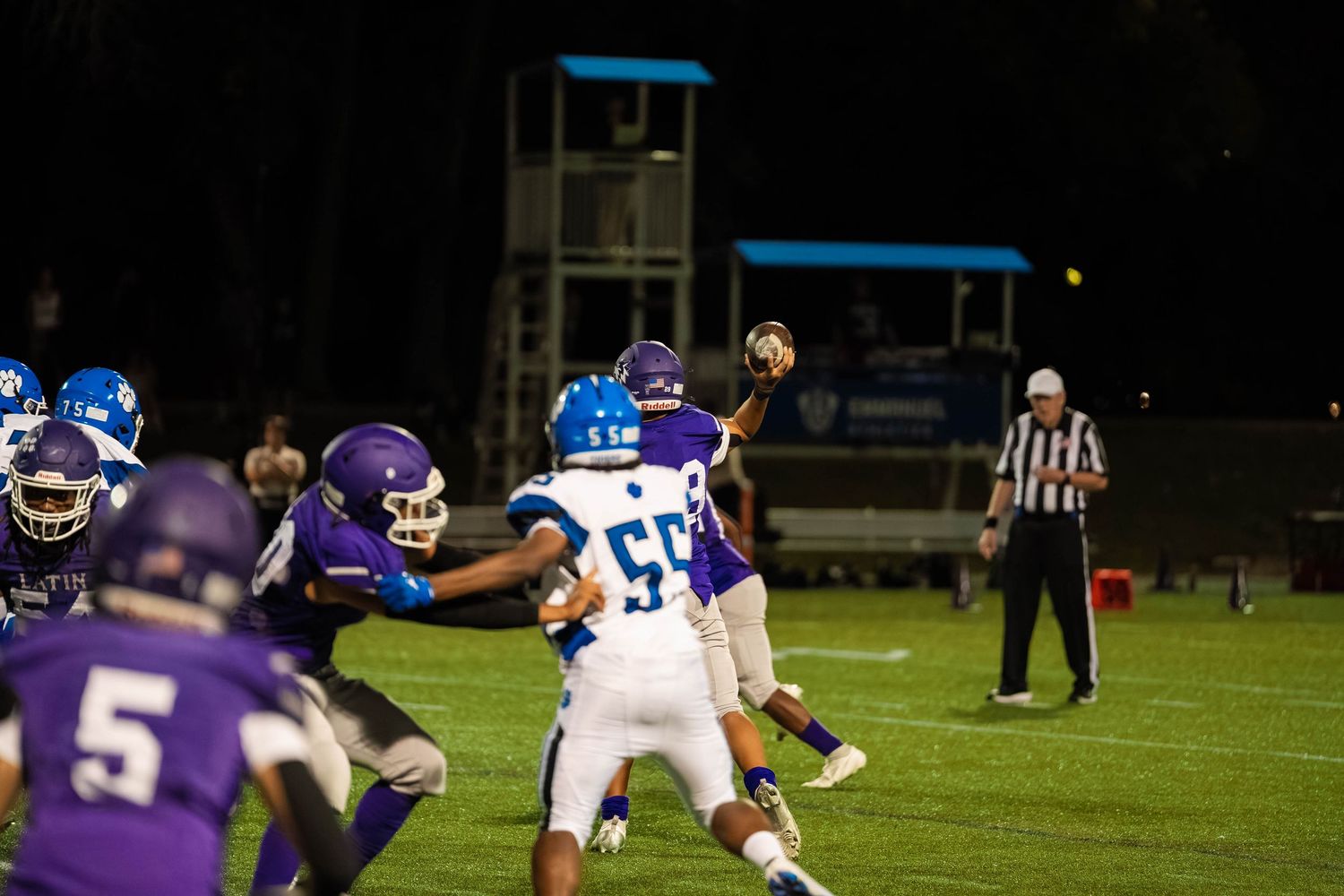 A quarterback charges up his throw.