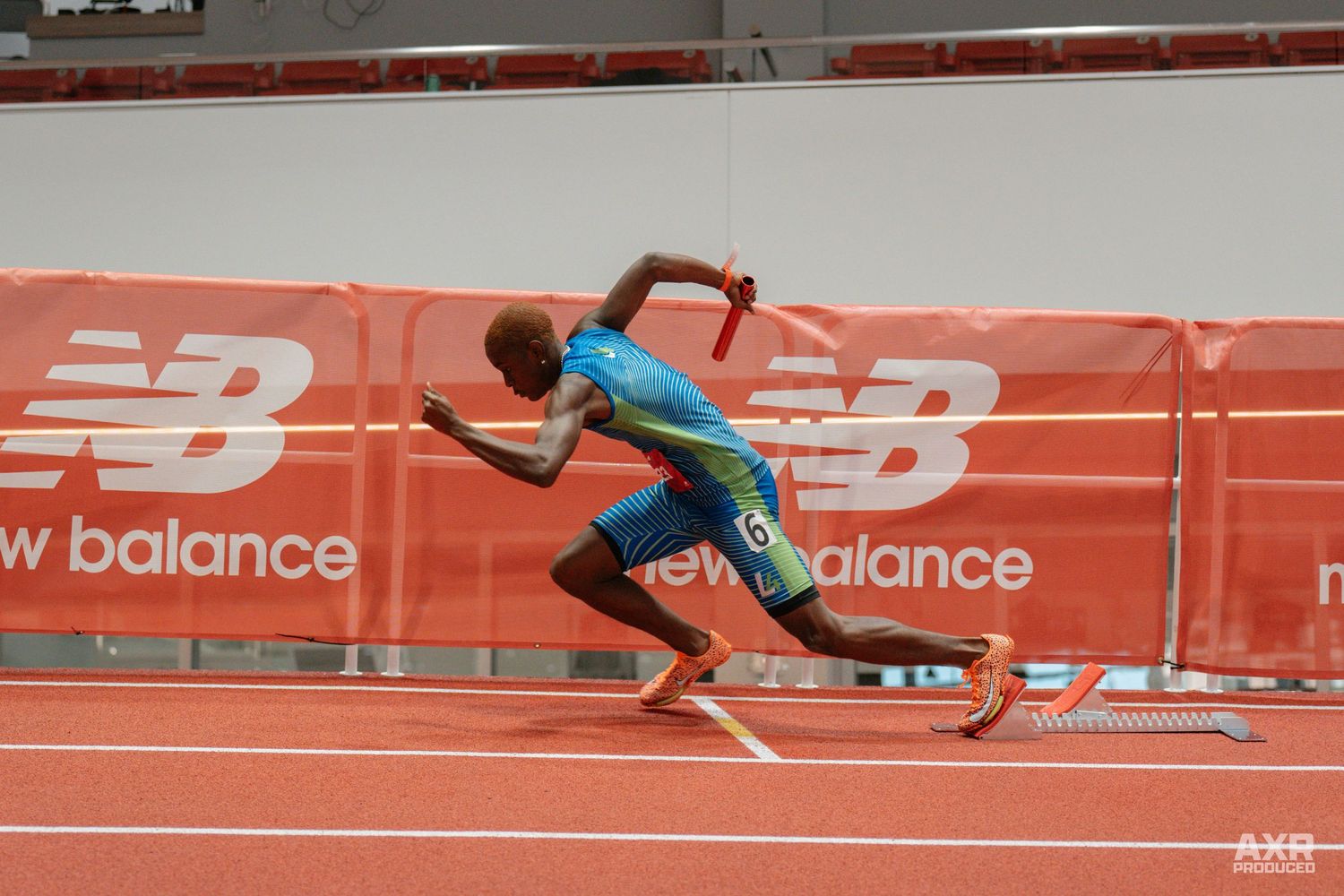 A guy dashes off his start block