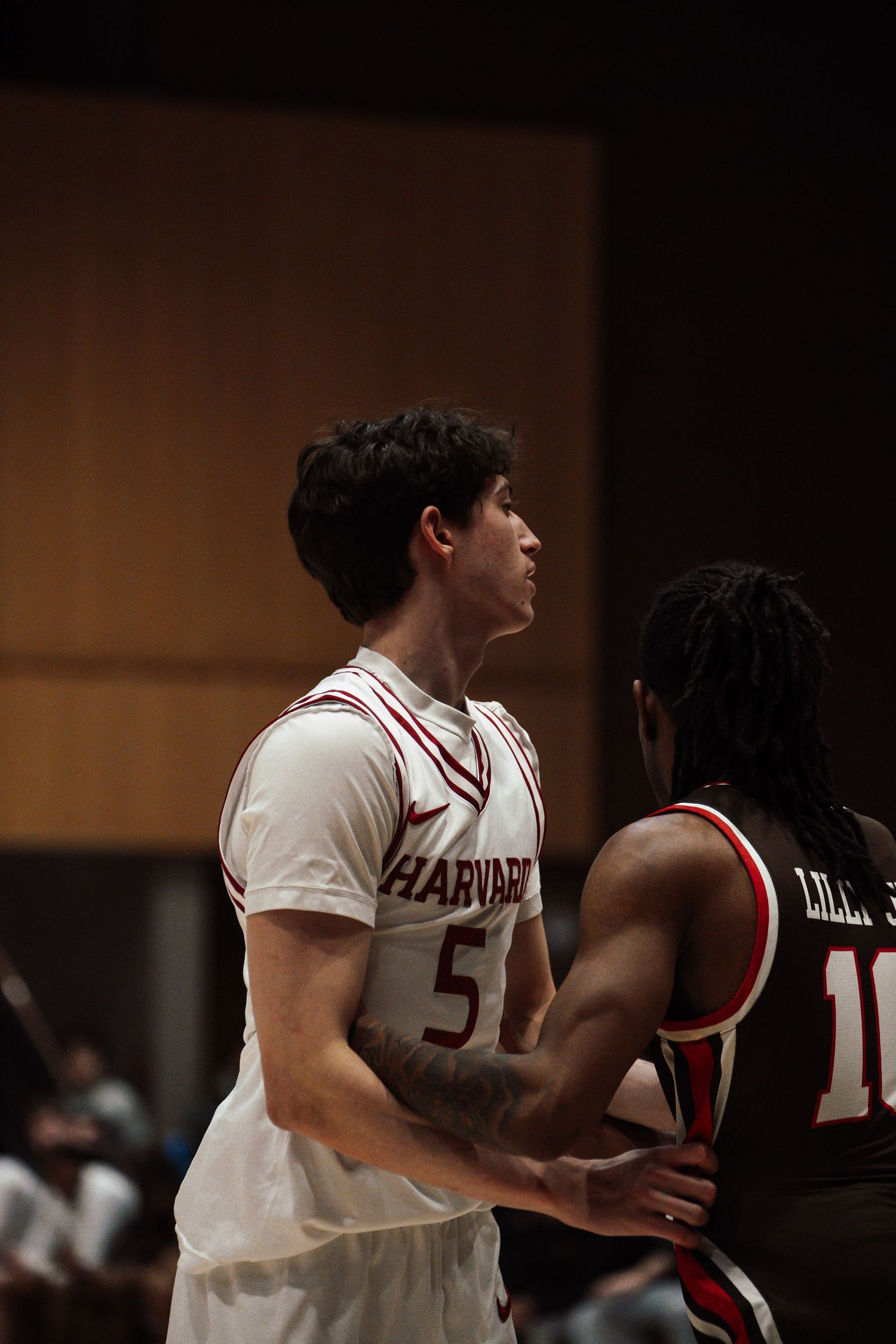 Harvard player guards an opponent.