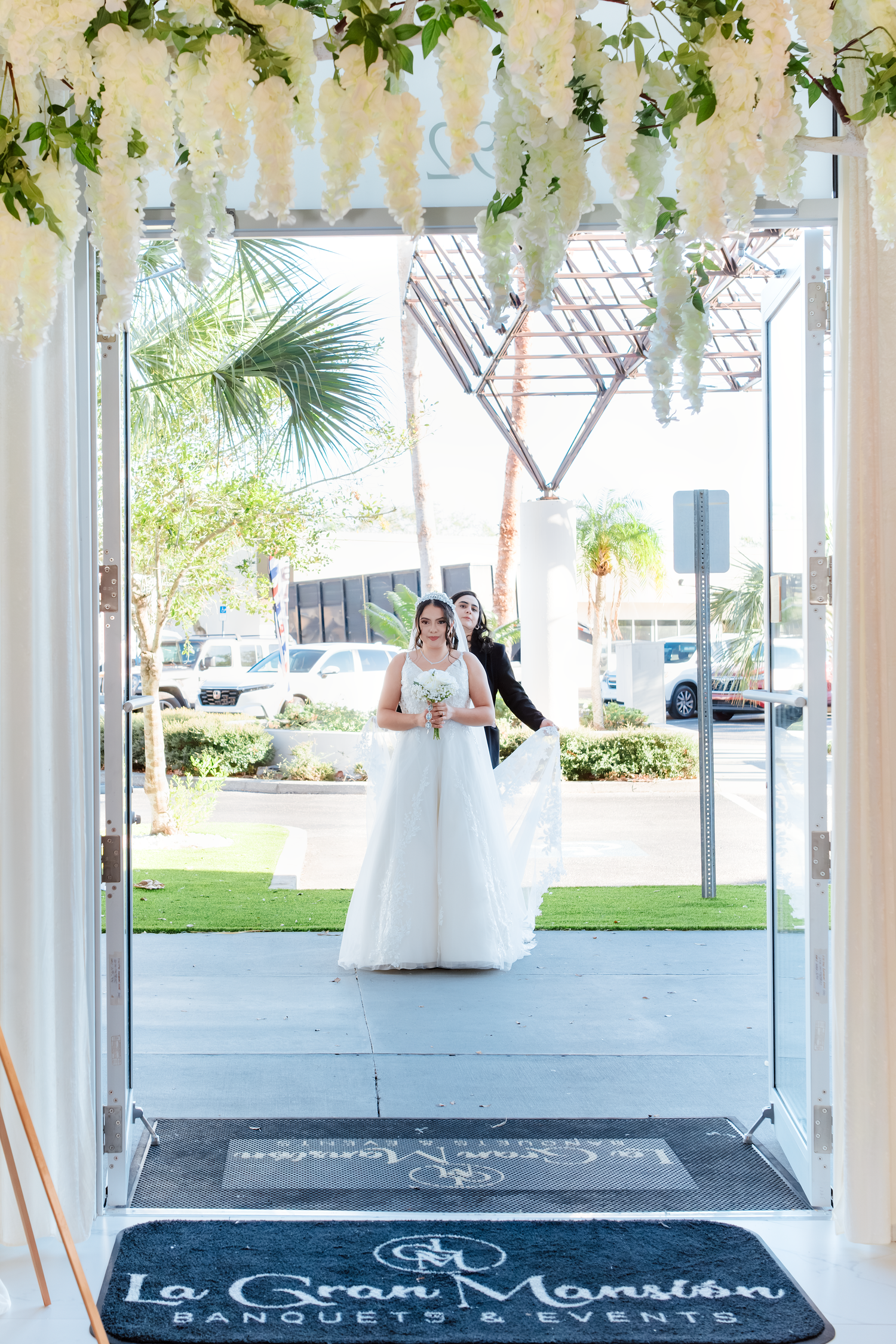 Bride and groom entering La Gran Mansion Banquets and Events venue on their wedding day.