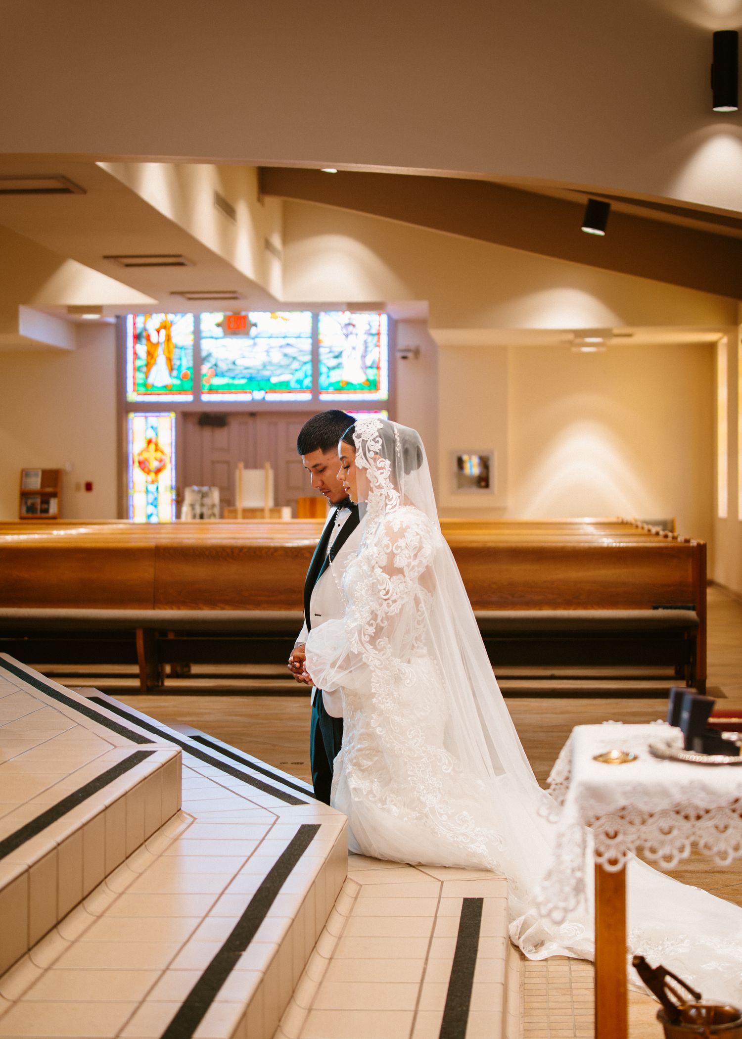 Bride and groom share intimate moment at church altar during traditional wedding ceremony.