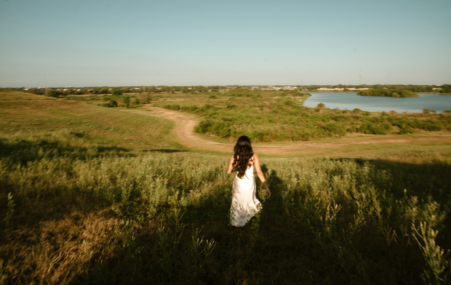 A series of panoramic landscape photos showing rolling hills, lakes, and natural terrain at sunset.