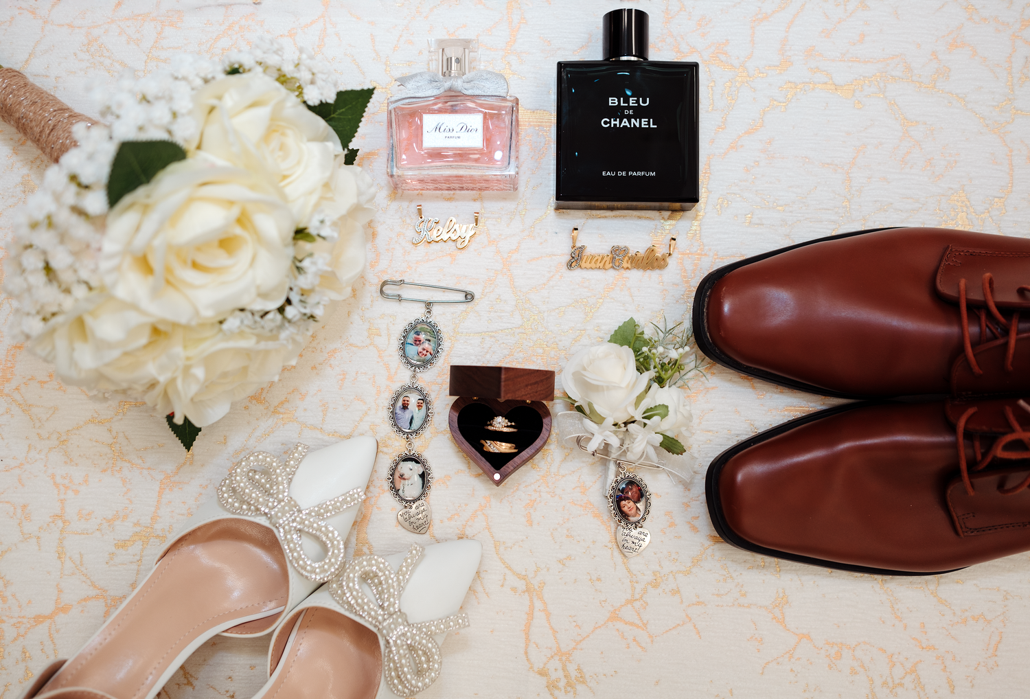 Wedding flat lay featuring bridal heels, Chanel cologne, Miss Dior perfume, and brown dress shoes.