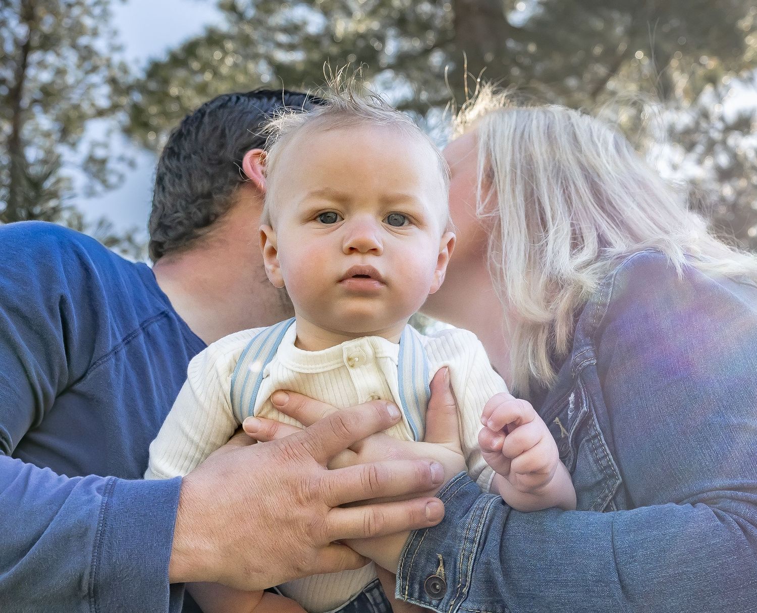 Intimate family moments captured in soft natural lighting outdoors.