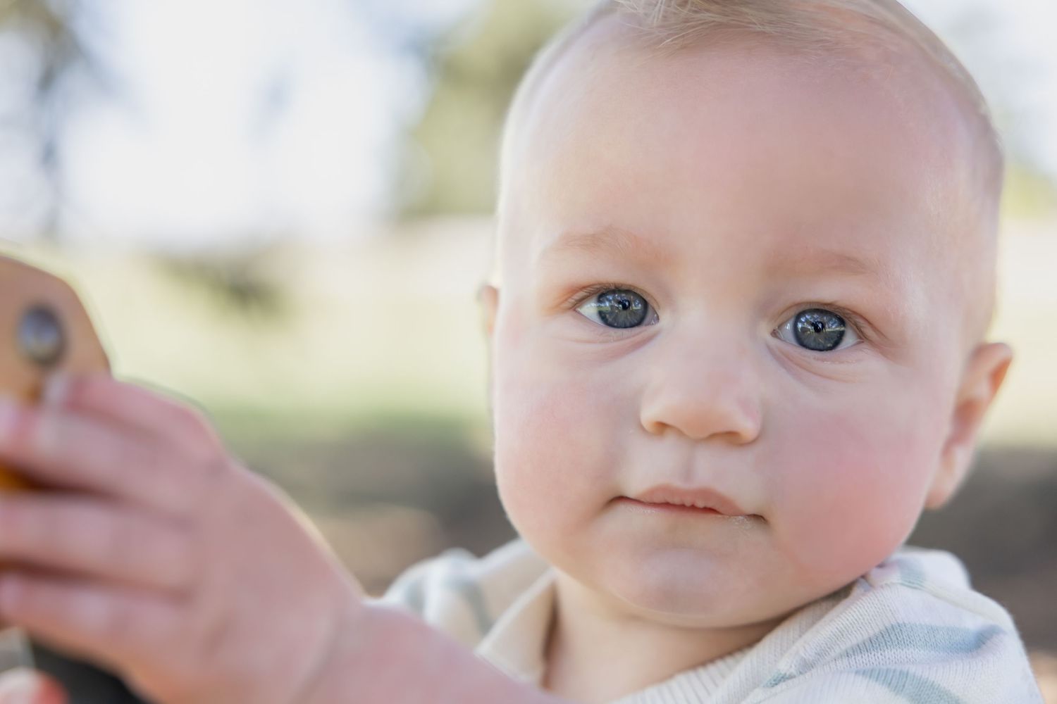 Close-up portrait showing bright blue eyes and gentle expression.
