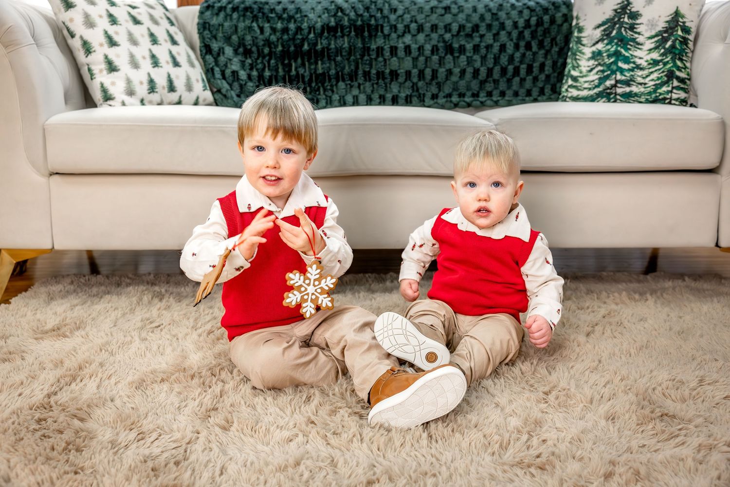 A progression of holiday photos shows a baby in red and white outfit crawling on beige carpet with Christmas decorations.