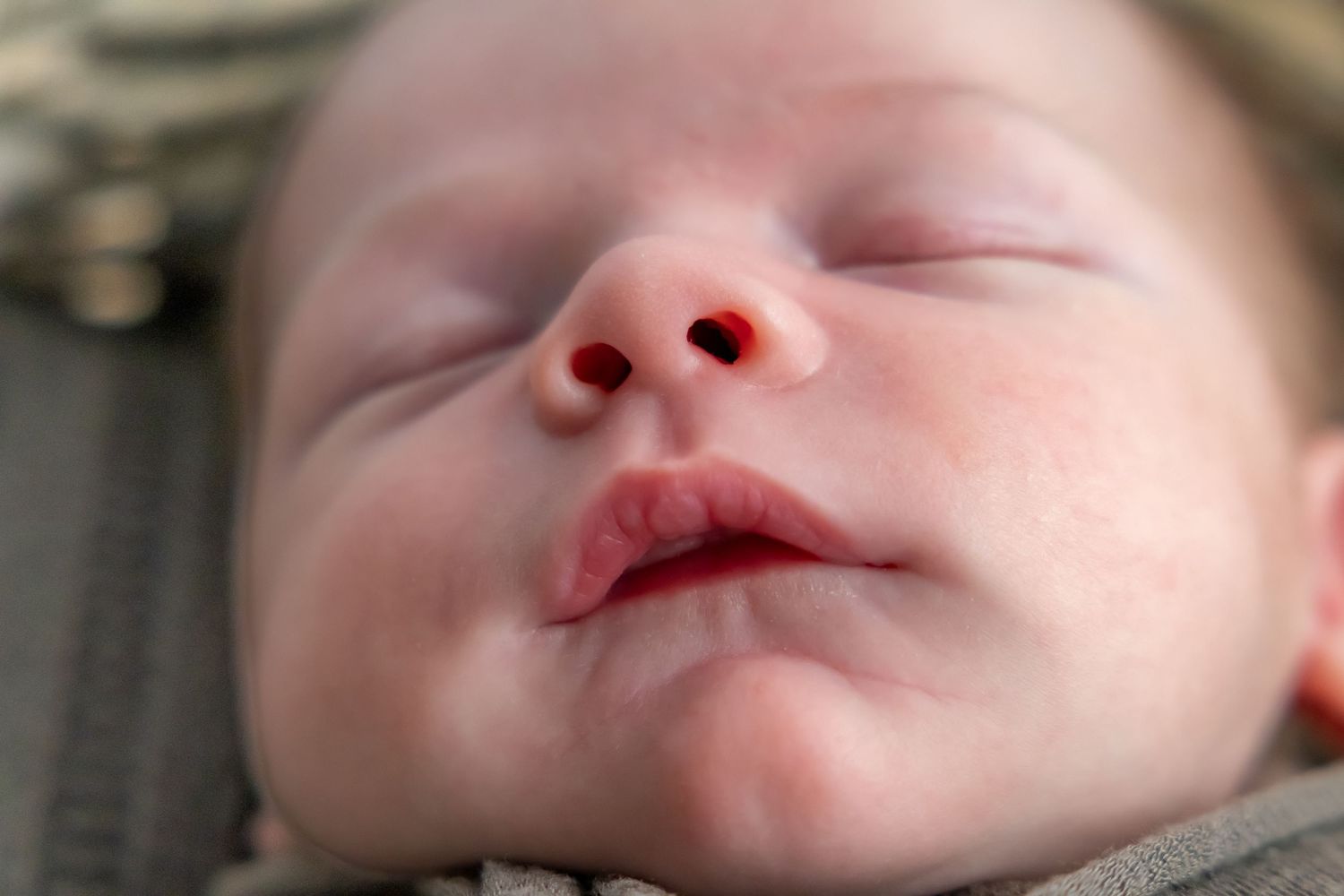 Close-up portrait of sleeping baby's face and features.
