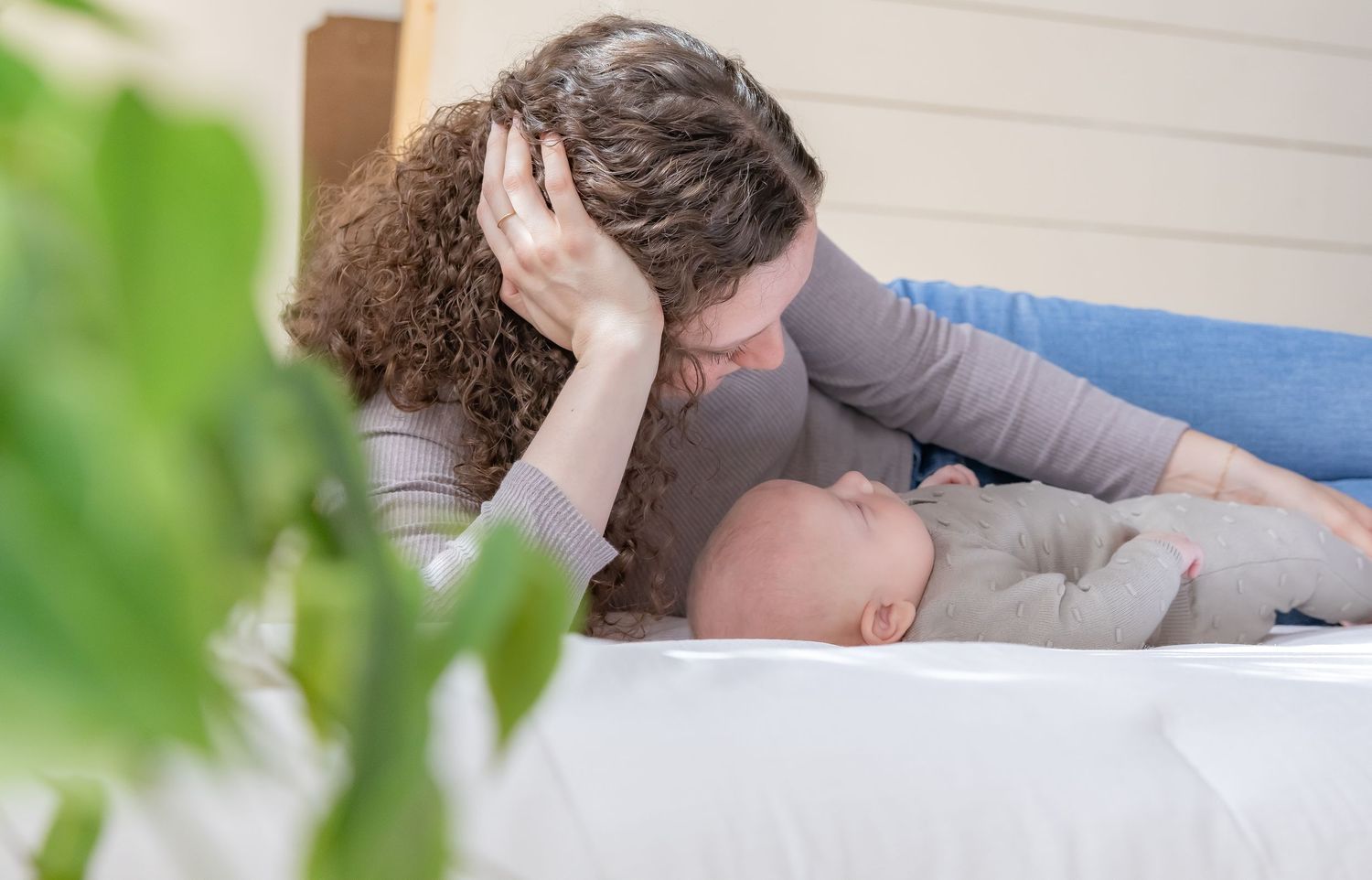 Lifestyle family photography session with natural window lighting and indoor setting.