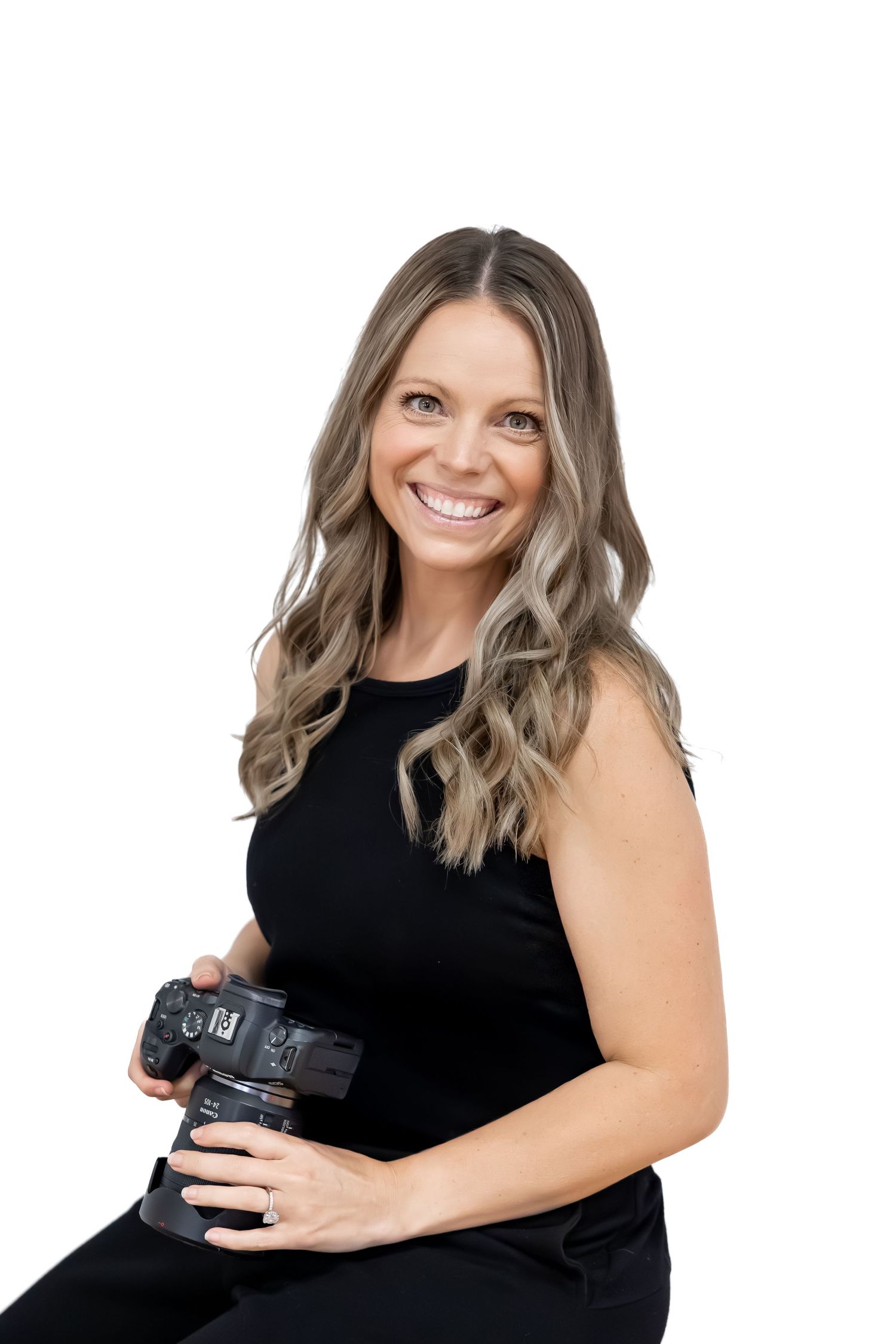 Professional photography studio setup with black backdrop and camera equipment.
