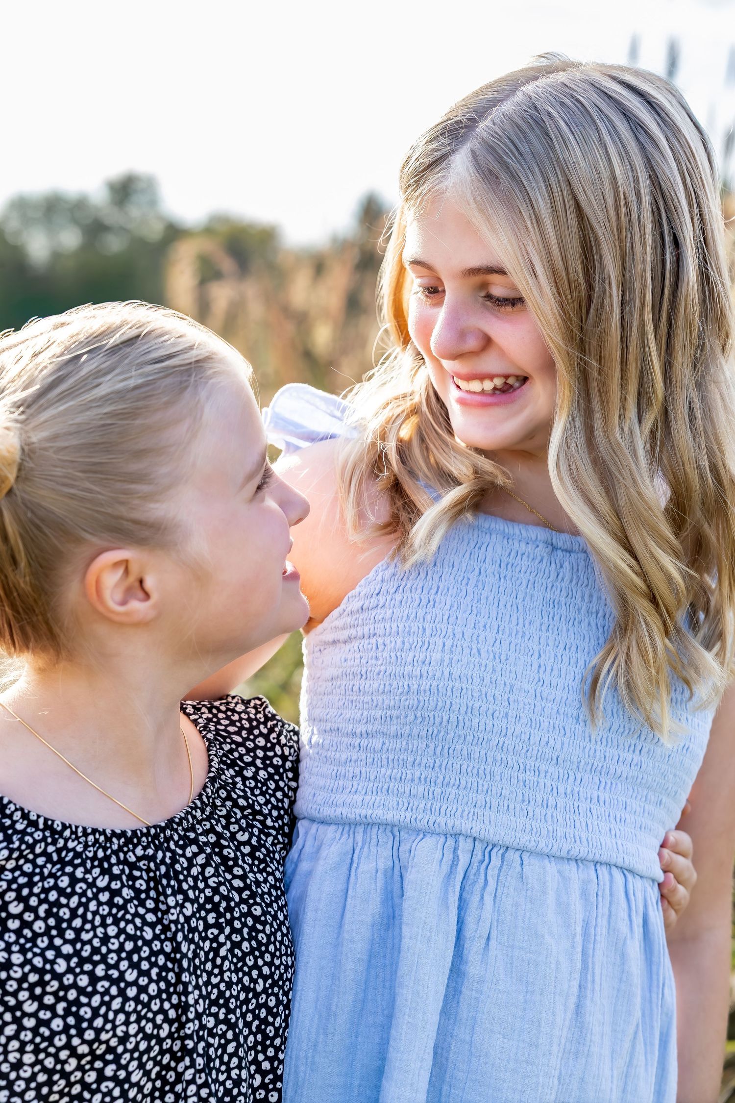 A sequence of candid outdoor photos showing joyful interaction between two people in summer clothing.