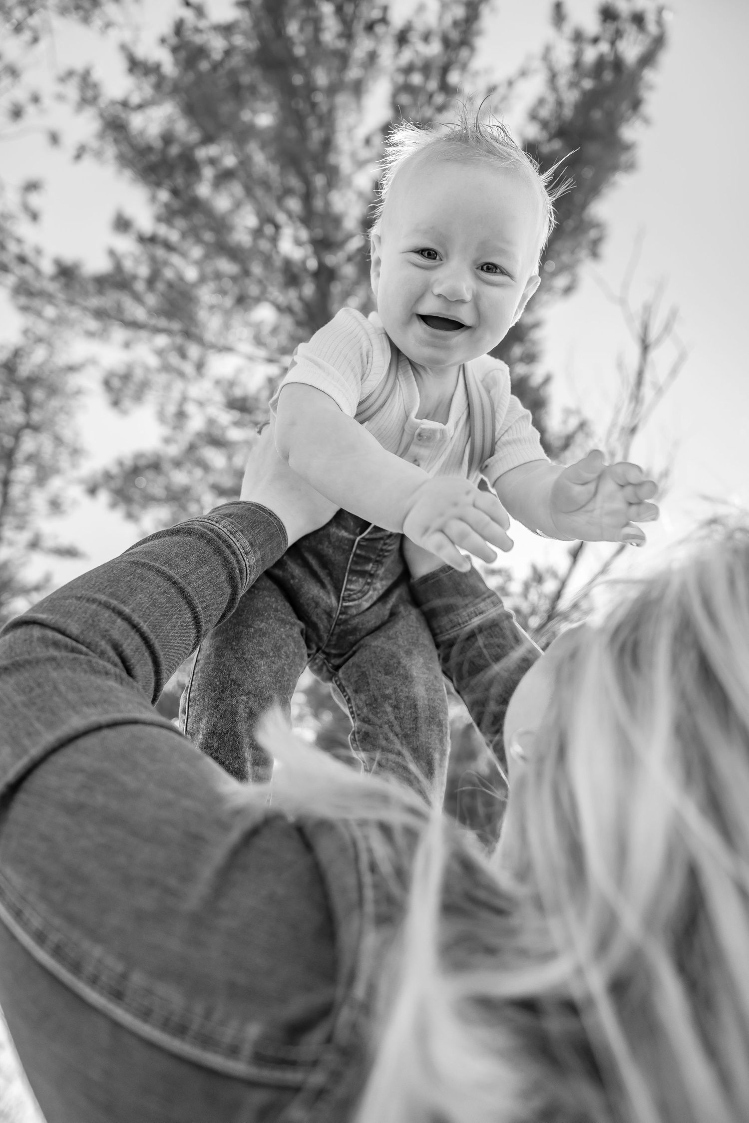 Black and white series of joyful family interactions captured from below.