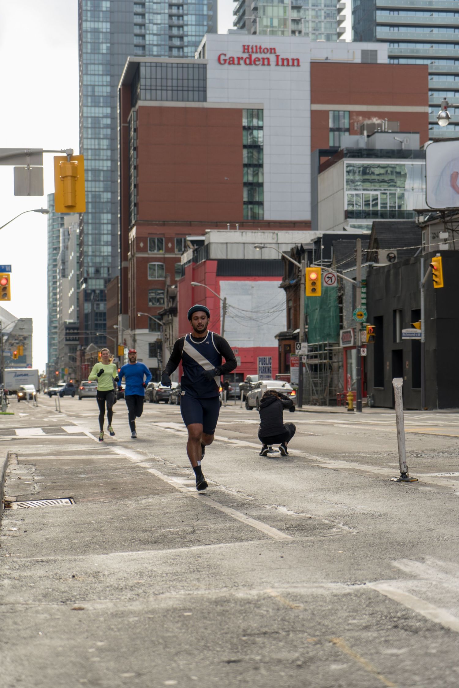 A determined man races in a marathon under rain, droplets falling around him as he pushes through the challenging weather.