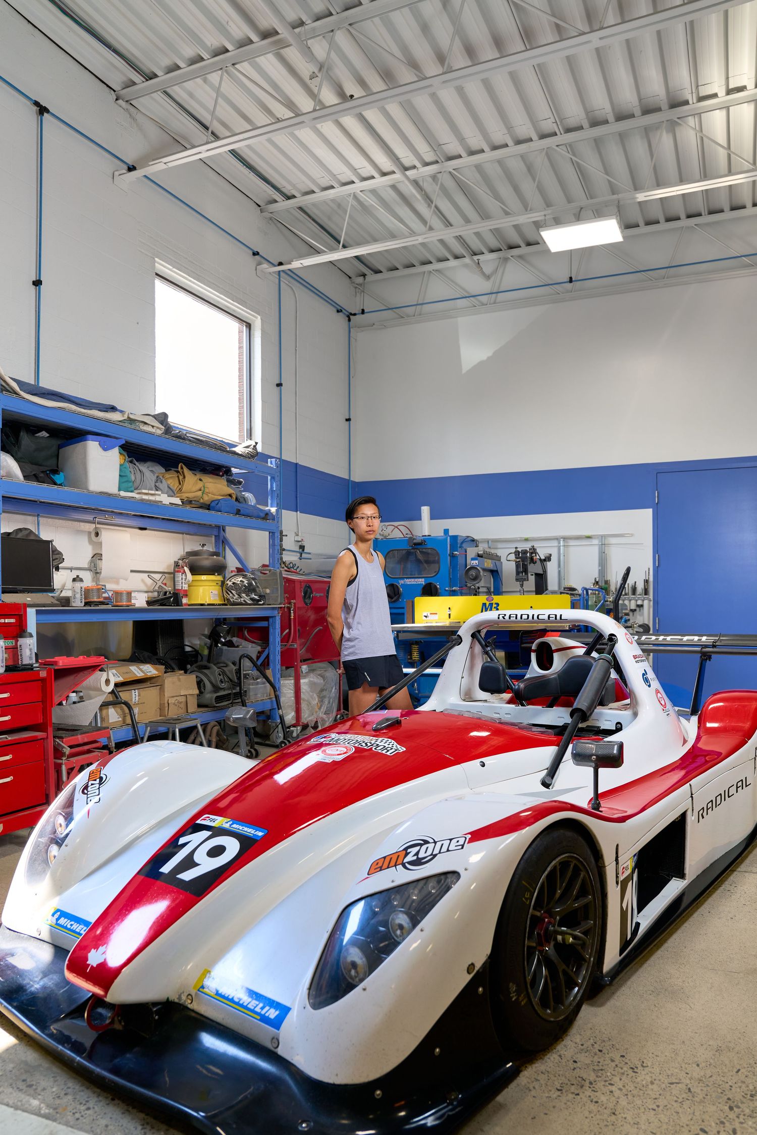 They atop a racing car, embodying the excitement and intensity of competitive racing.