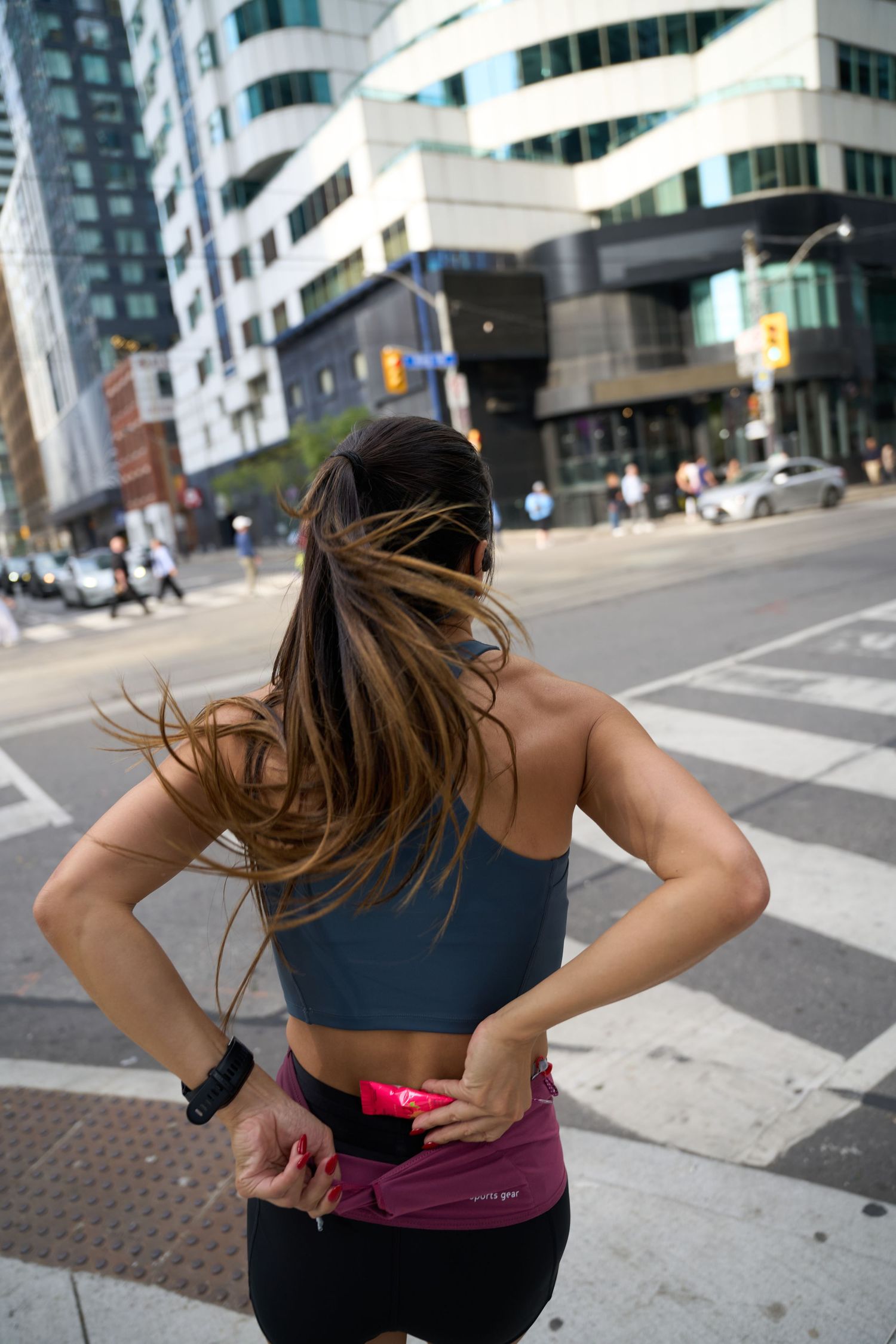 A man and woman jogging in front of a colorful wall, capturing a moment of fitness and companionship in motion.
