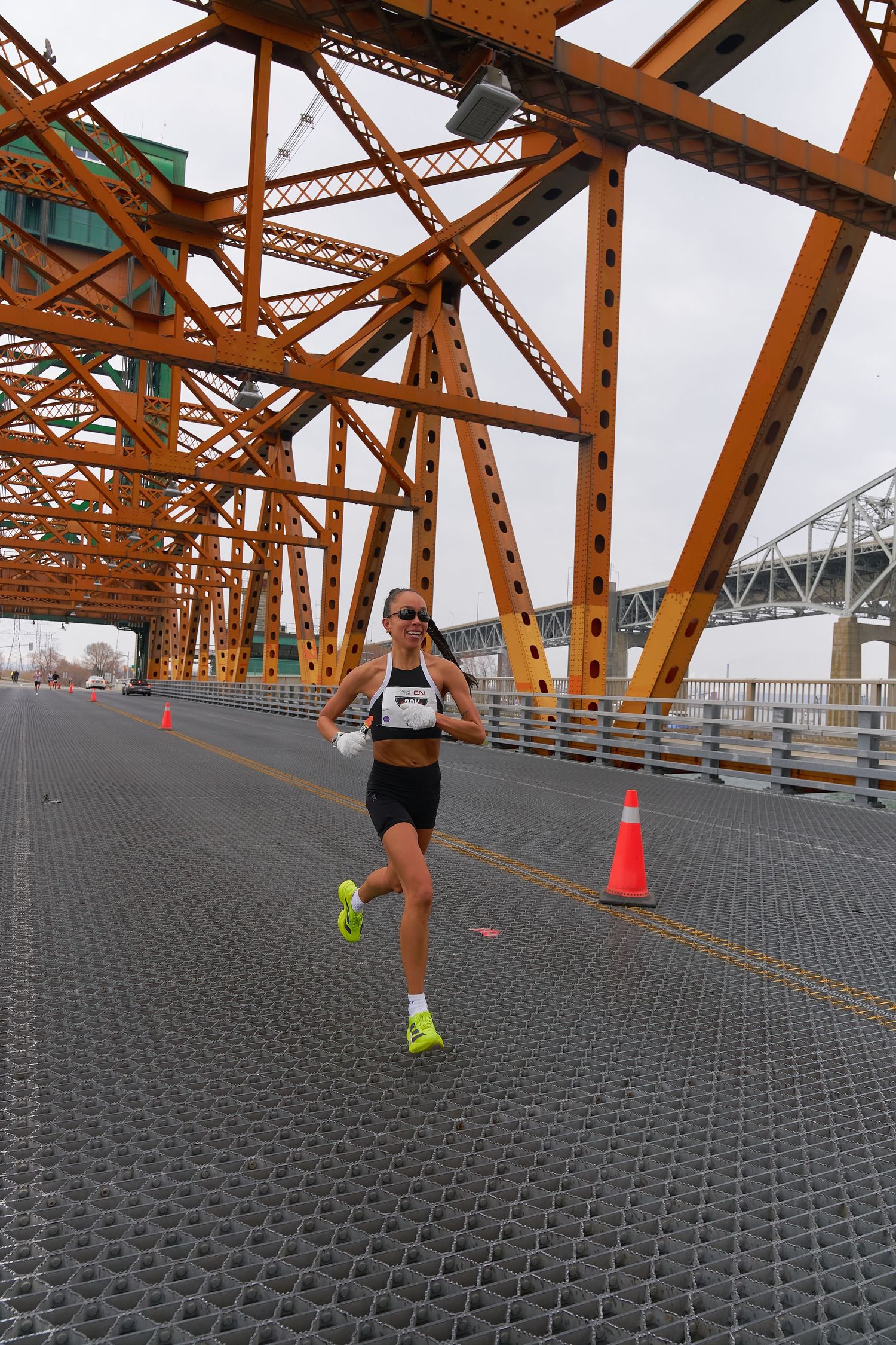 A engaged in jogging beneath a bridge, highlighting their athletic attire and resolve as they partake in outdoor exercise.