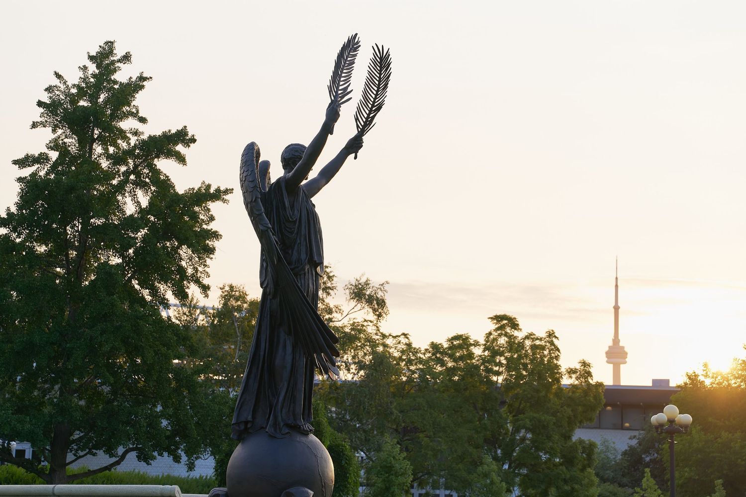 A statue of an angel holding a bird delicately in its hand, symbolizing peace and protection.
