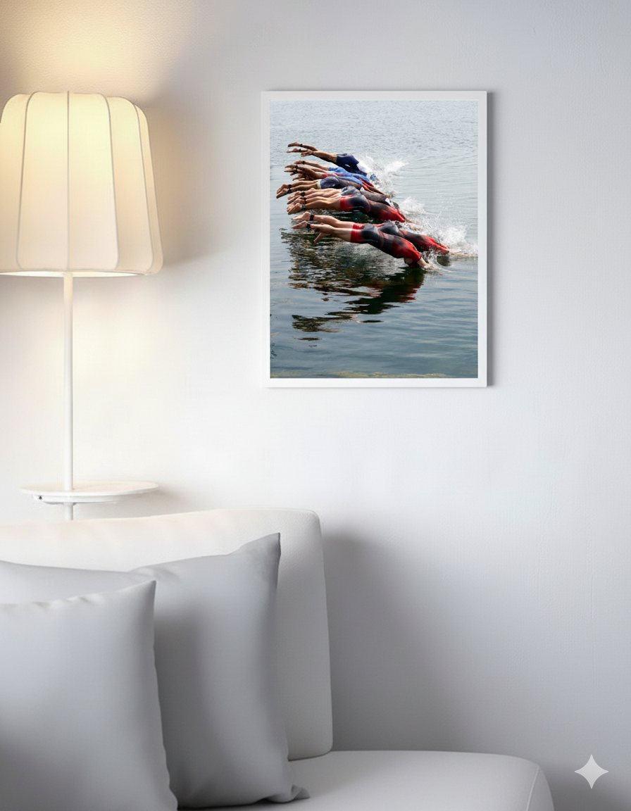 A white couch with a framed picture of a swimmer, enhancing the aesthetic of the living space.