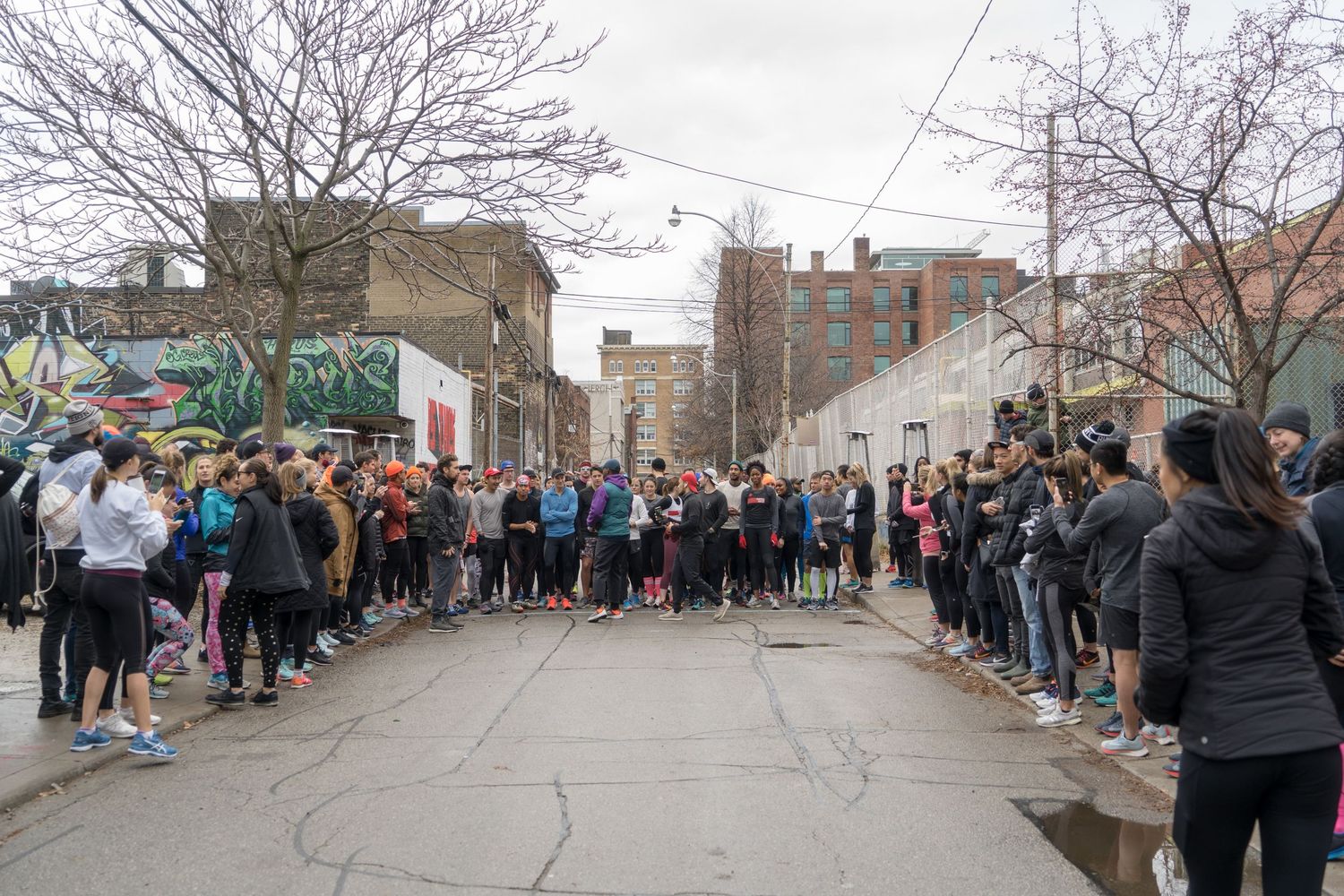 A lively scene of marathon participants, featuring a mix of ages and backgrounds, all focused on the finish line ahead.