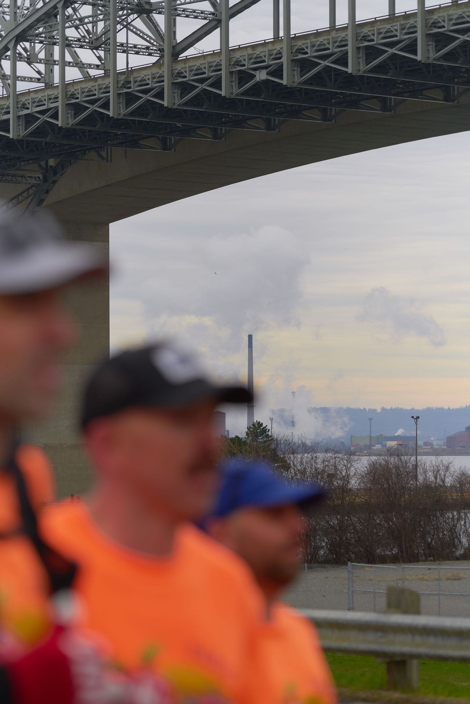 jogging beneath a bridge, showcasing their athletic wear and determination as they exercise outdoors.