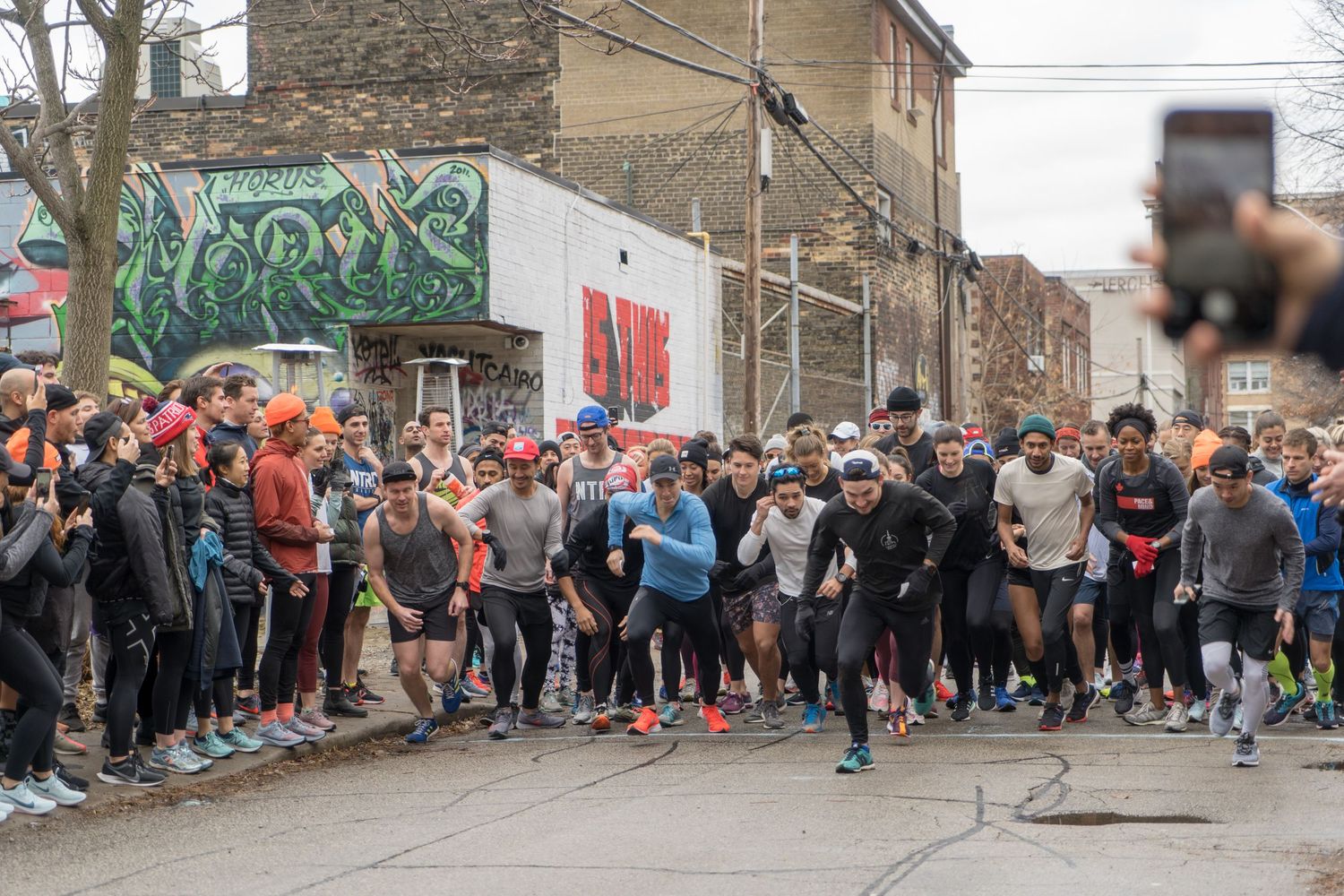 A vibrant group of athletes running in a marathon, displaying energy and enthusiasm as they compete together.