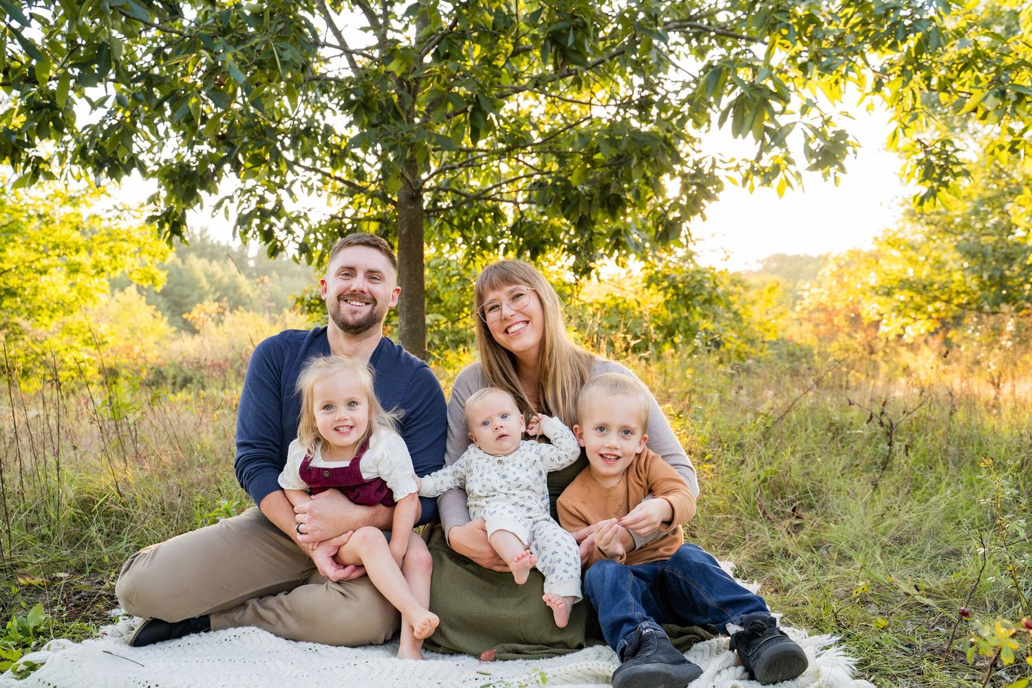 Family portrait with young kids outdoors on a sunny autumn day in Eau Claire Wisconsin