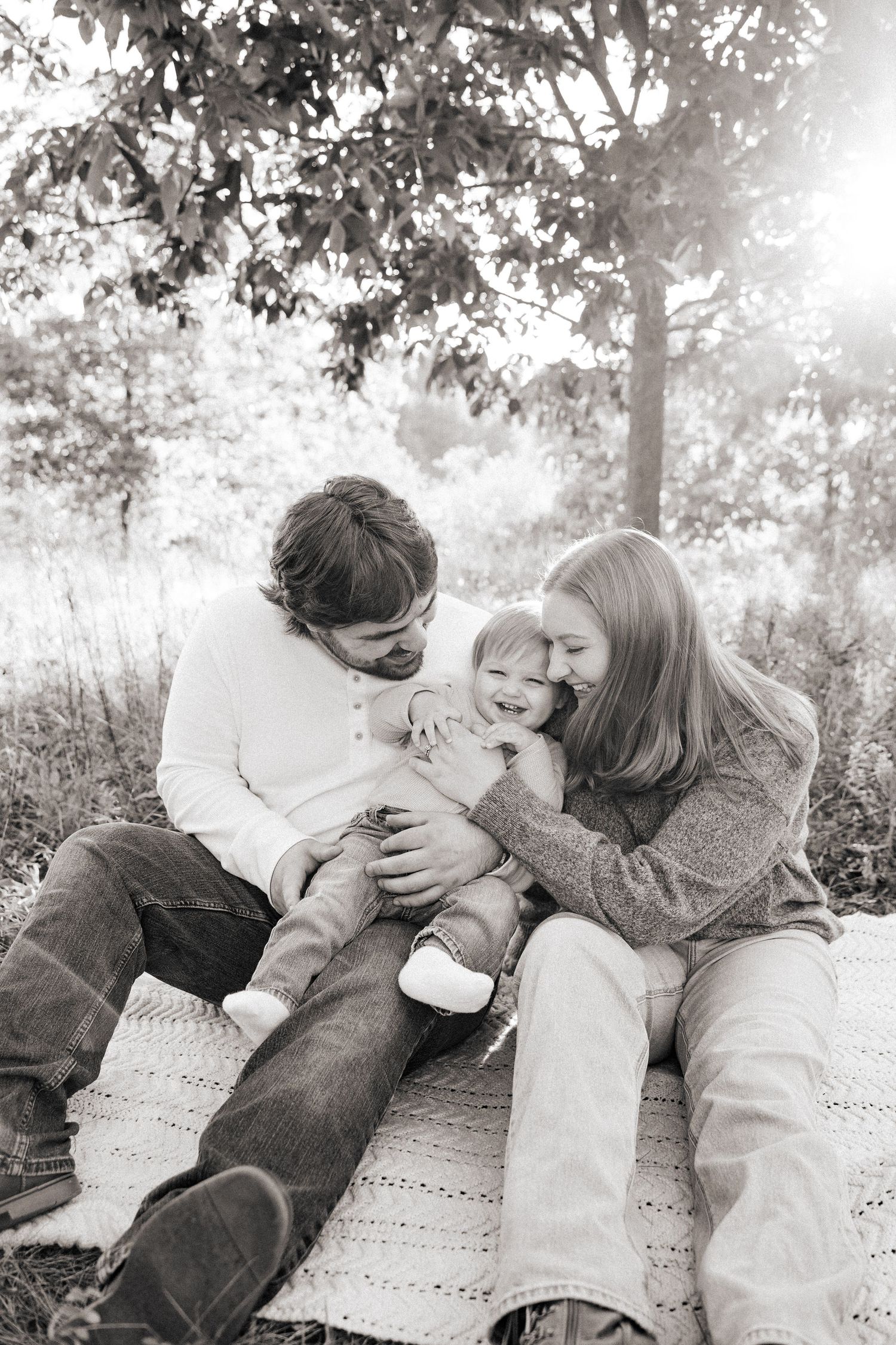 Black and white sequence showing tender moments between family members in an outdoor setting.