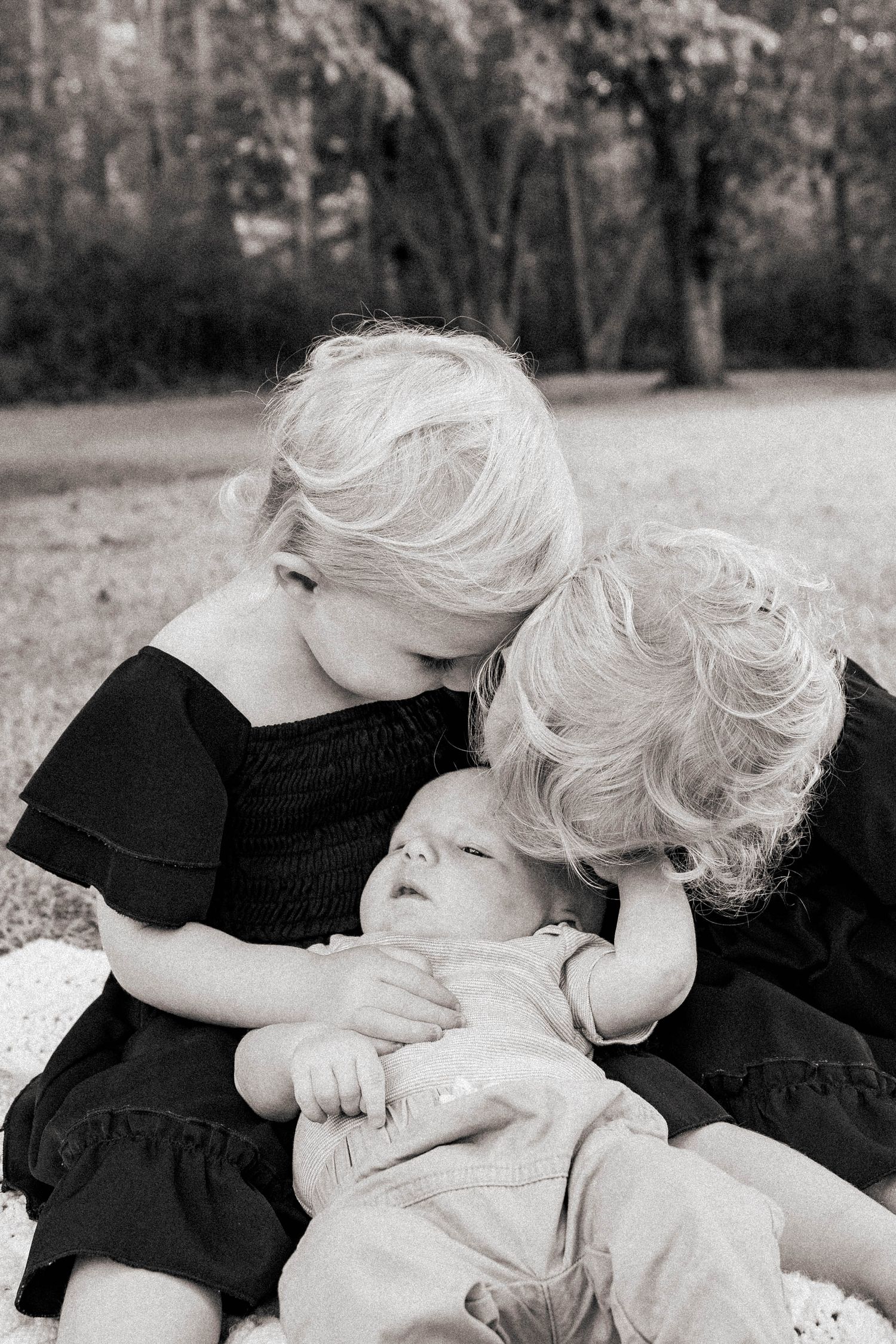 Black and white series of tender moments between two people in natural setting.