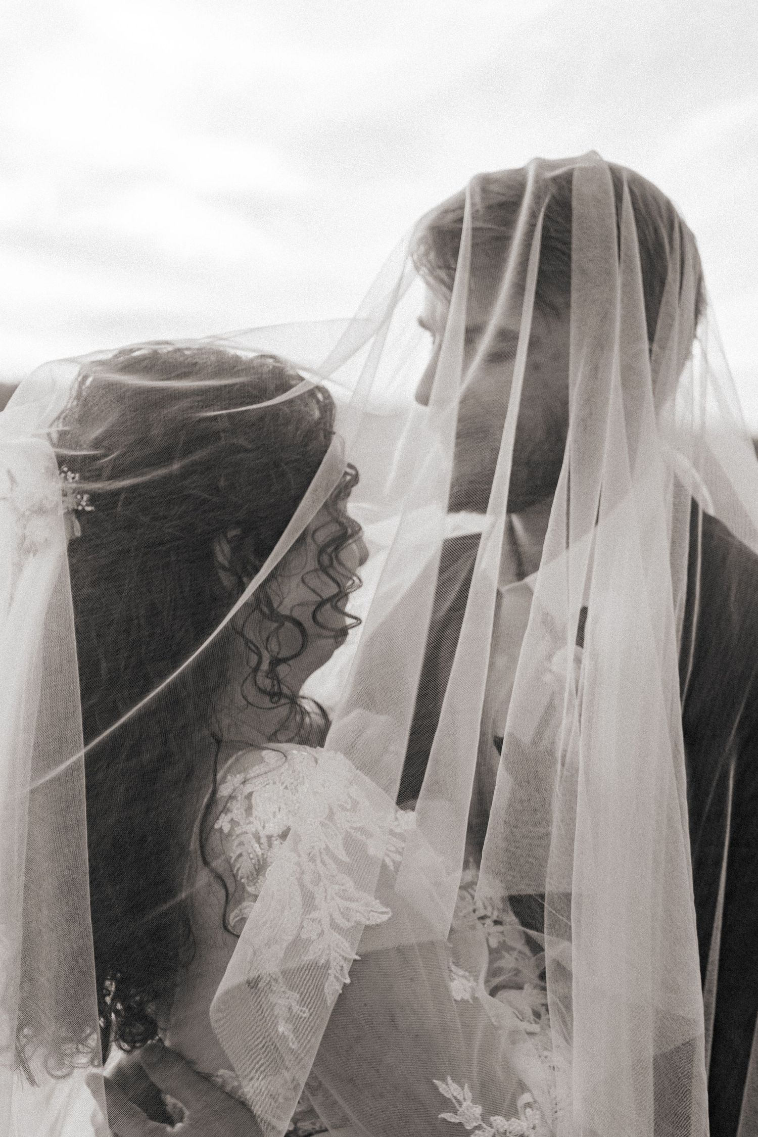 Artistic black and white photo series showing delicate bridal veils flowing in the breeze.