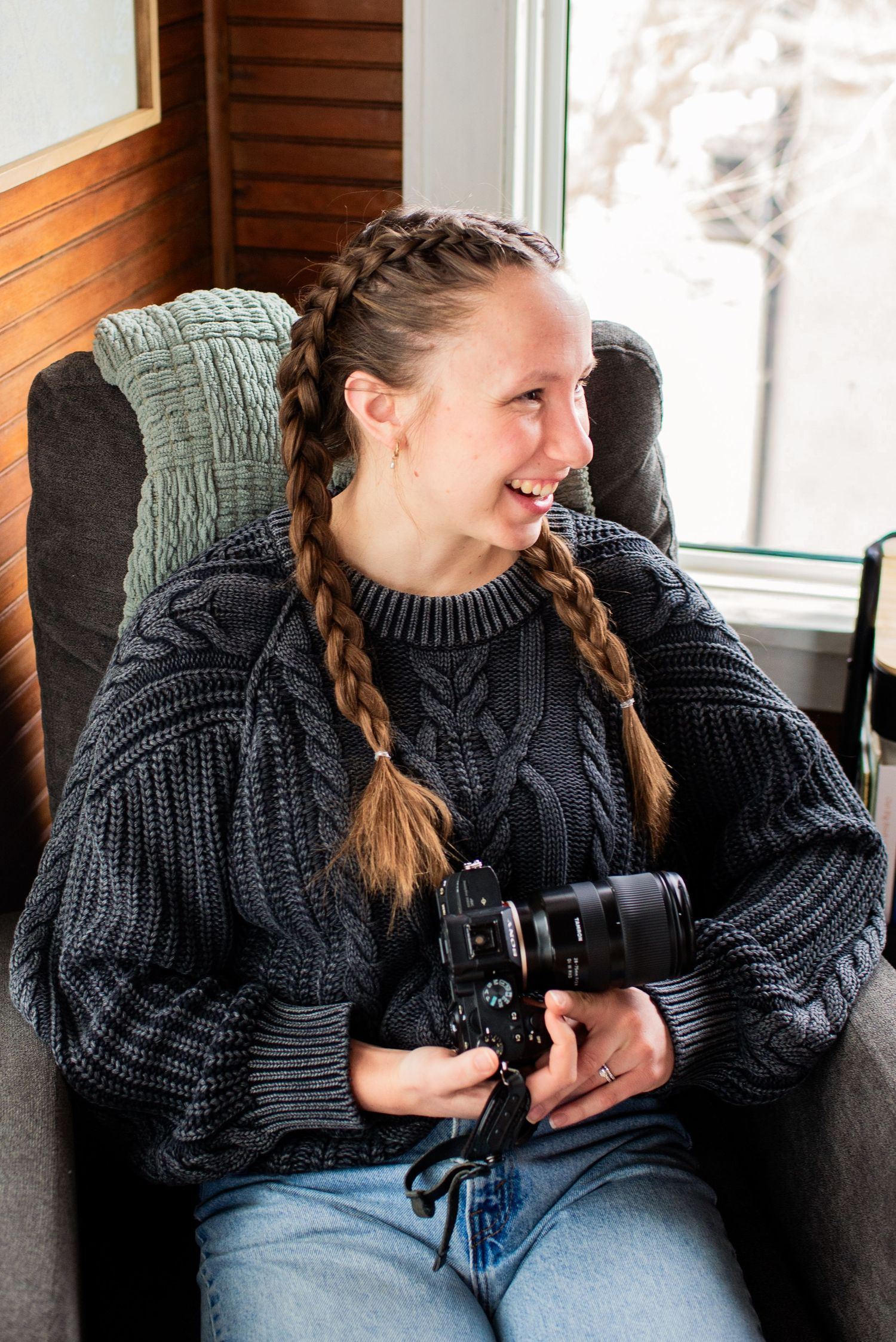 Kayla, owner of Abide Photography, smiling in office in Eau Claire, Wisconsin