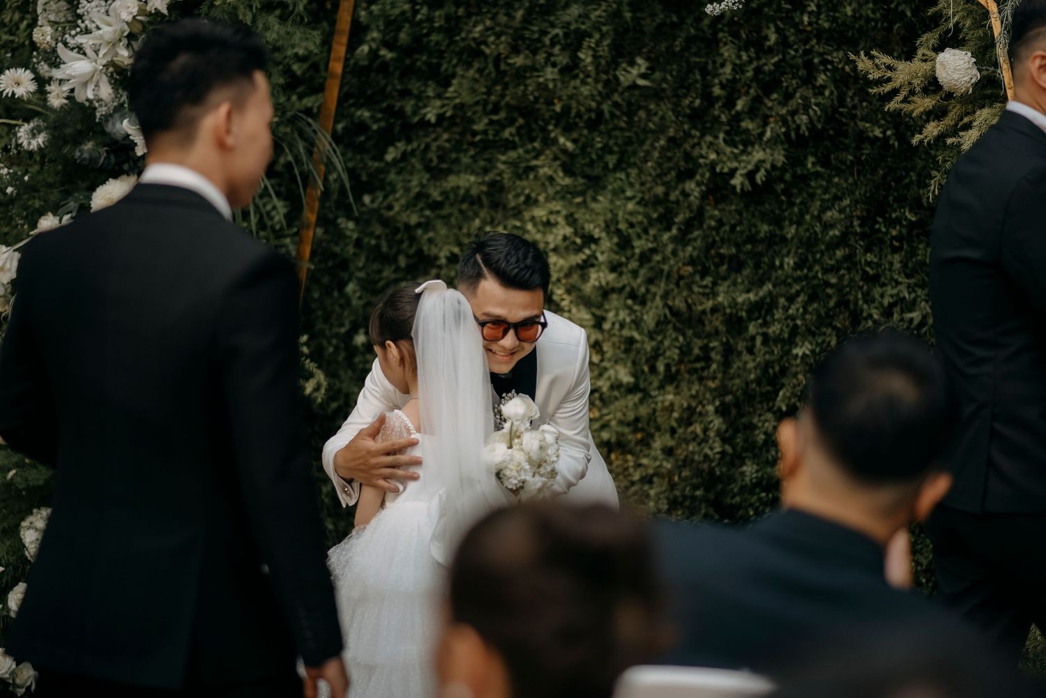 An emotional moment captured during an outdoor garden wedding ceremony.