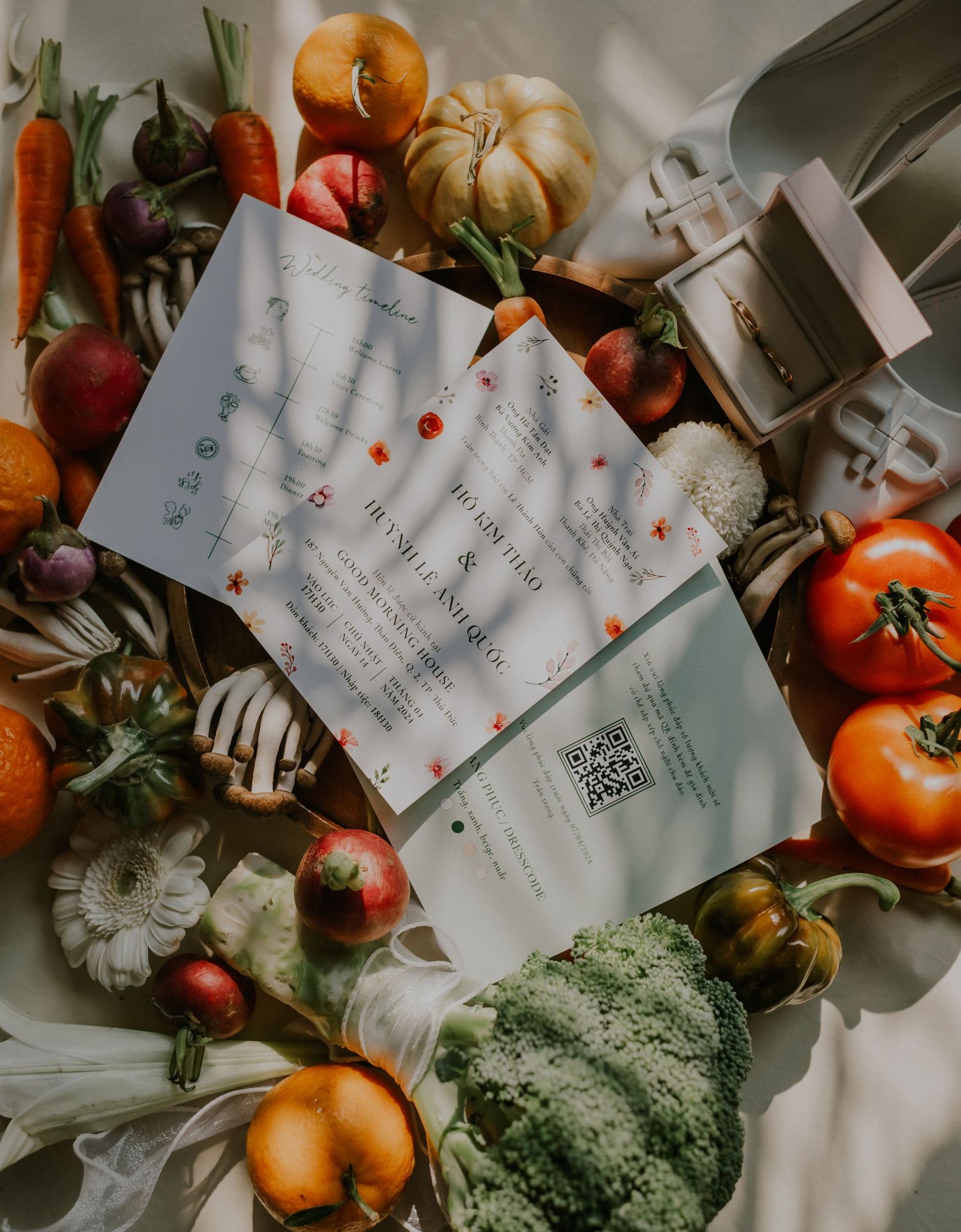 Flatlay of fresh produce and menu planning documents with QR codes.