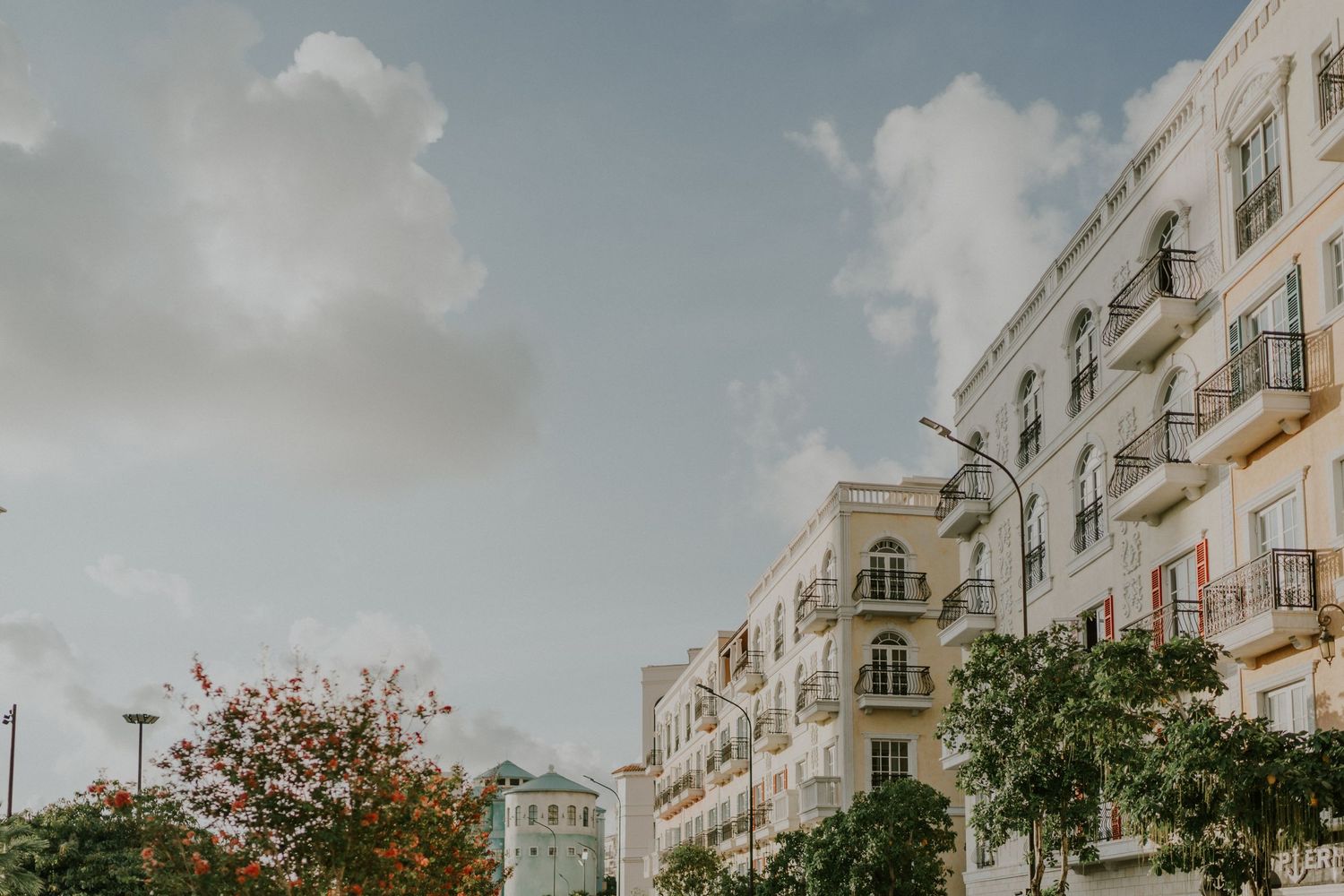 Classic European-style apartment buildings with ornate architecture against a cloudy sky.