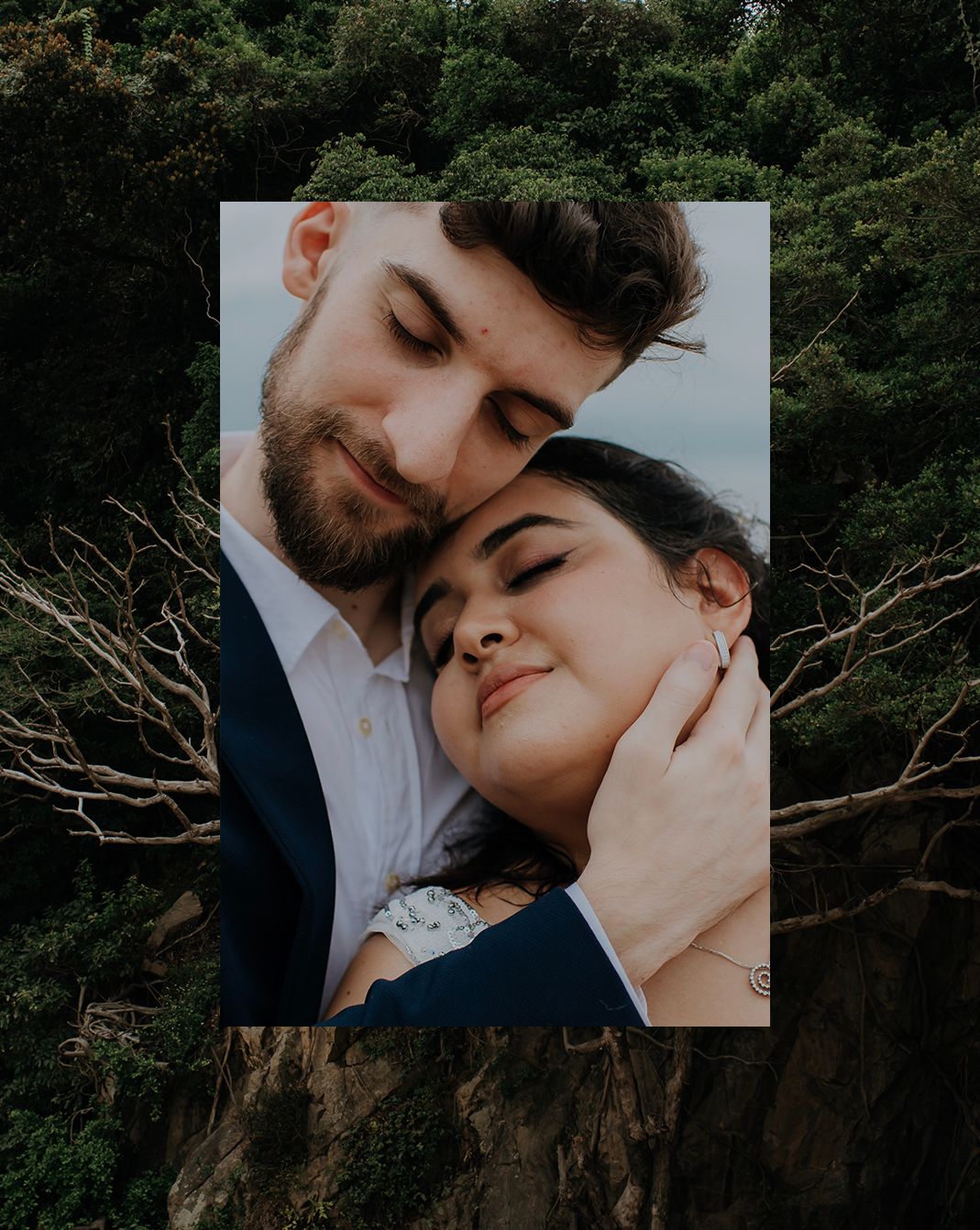 Close-up intimate portrait of a couple against a natural forest backdrop.