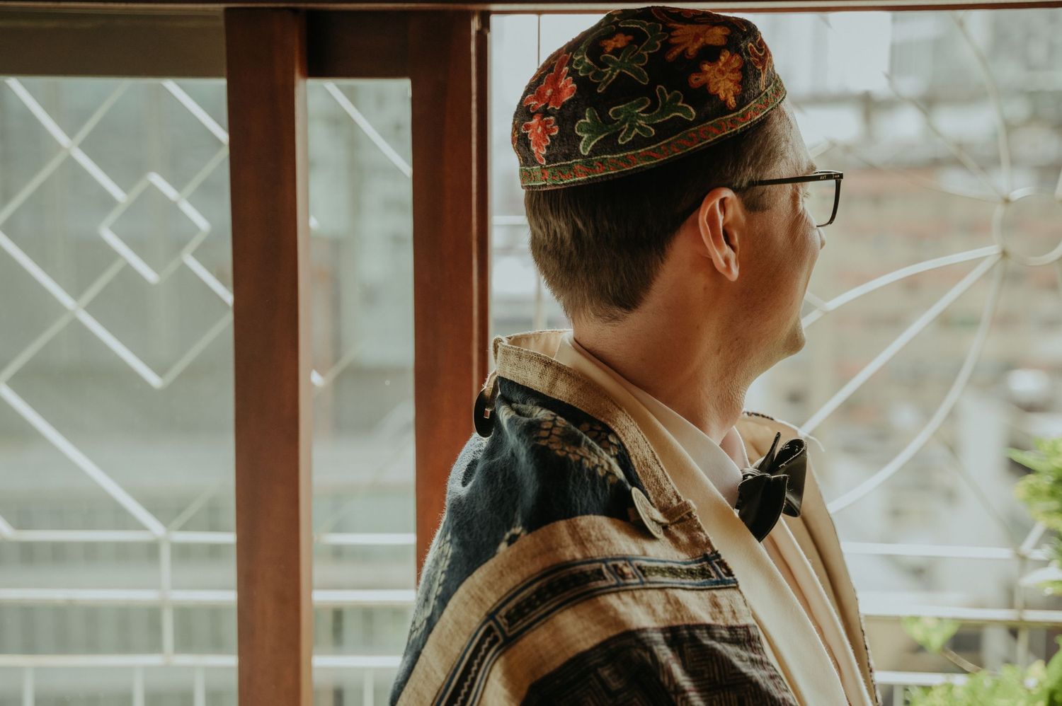 Side profile of a person wearing a traditional kippah and suit.