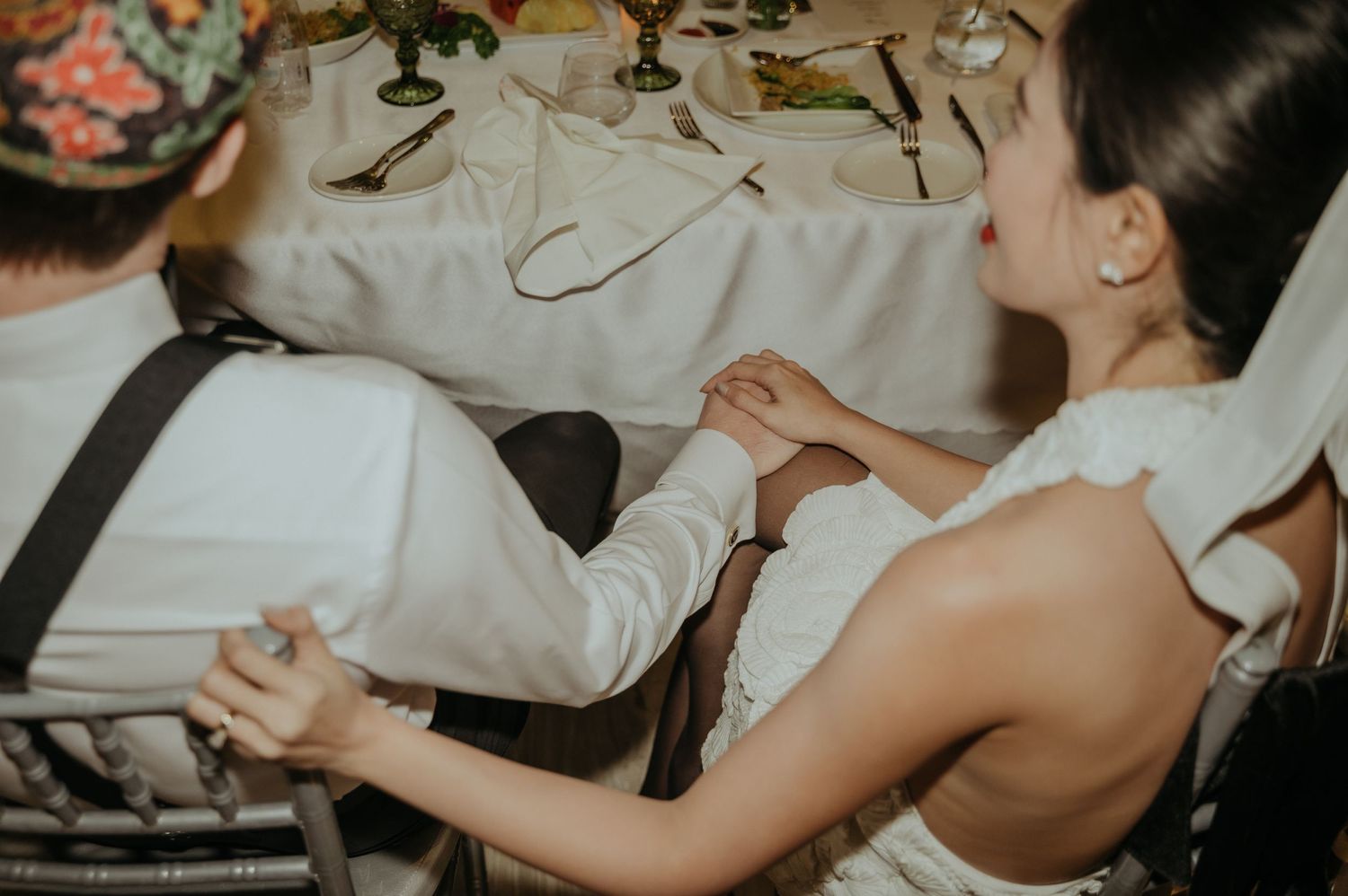 Someone adjusts formal attire during wedding preparations.