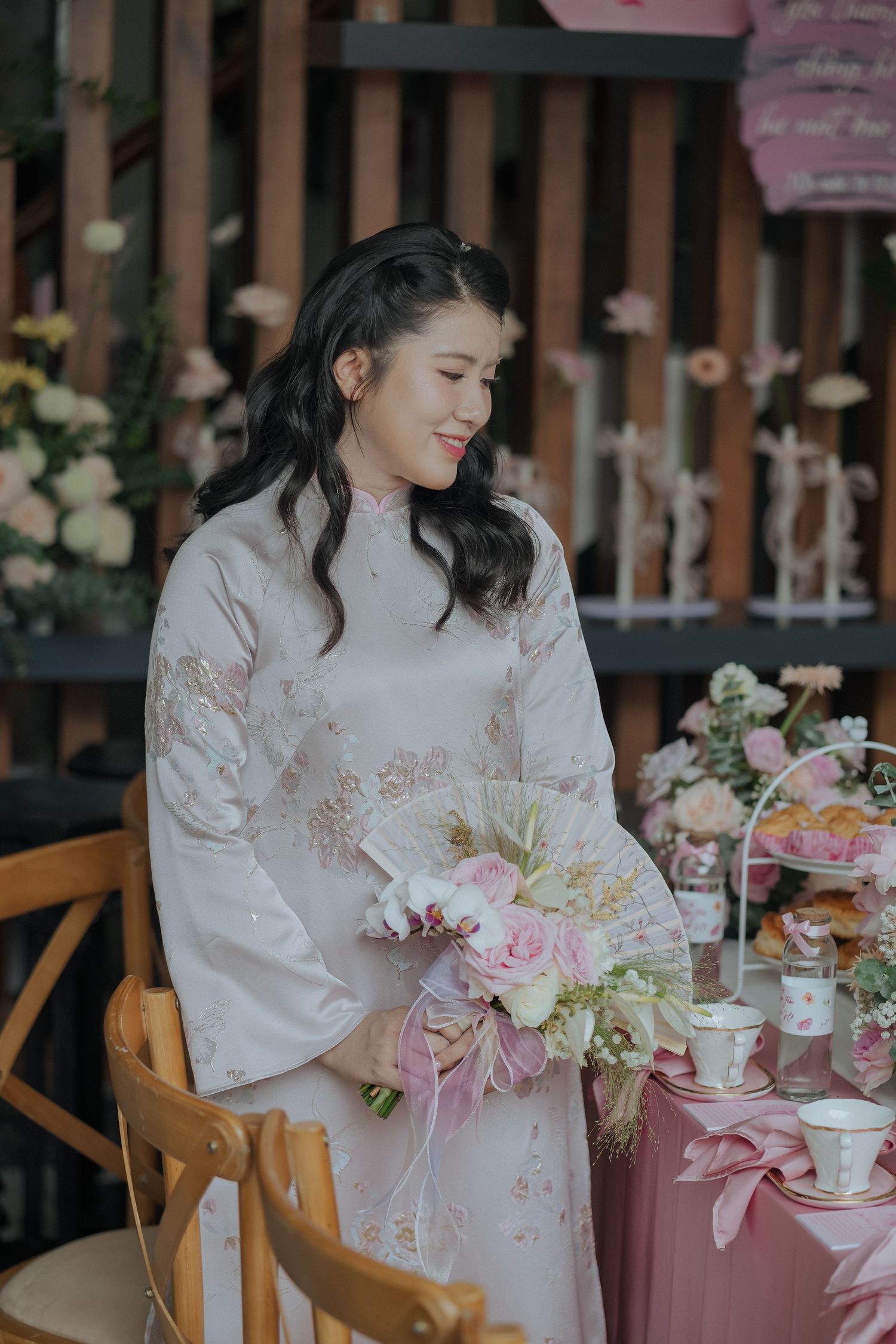 Elegant traditional attire with pink and white floral arrangements.