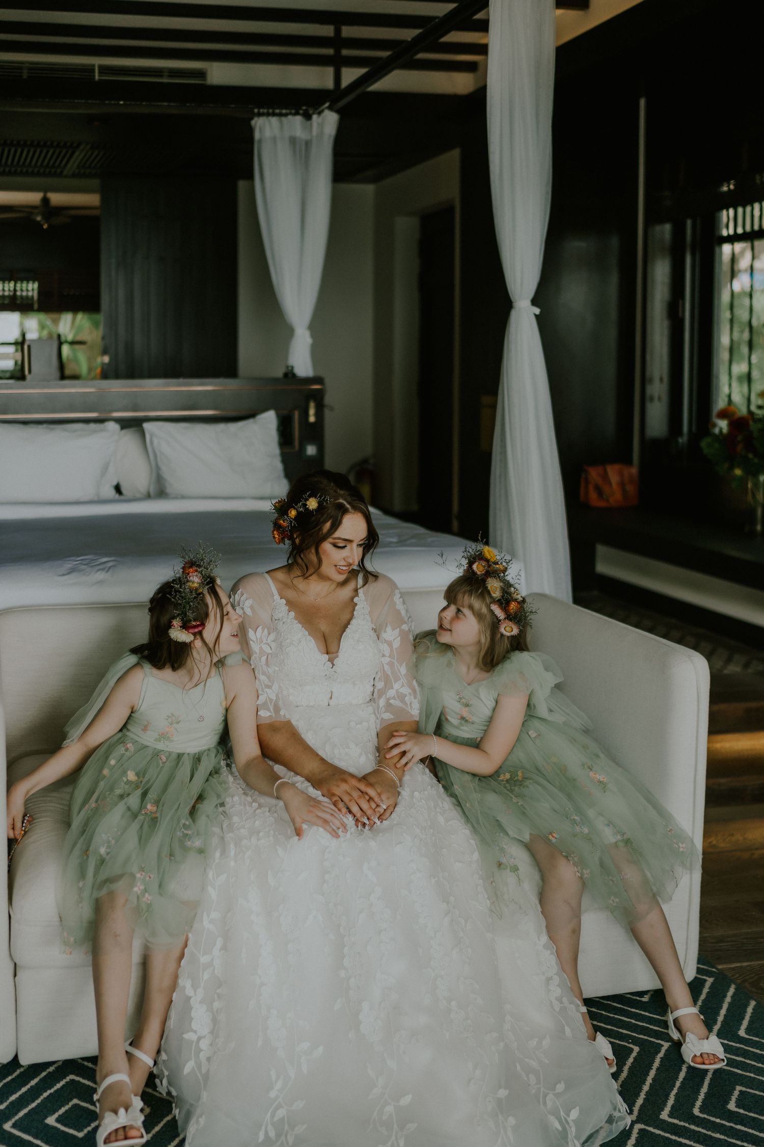Wedding scene in an elegant bedroom with white and mint green attire.