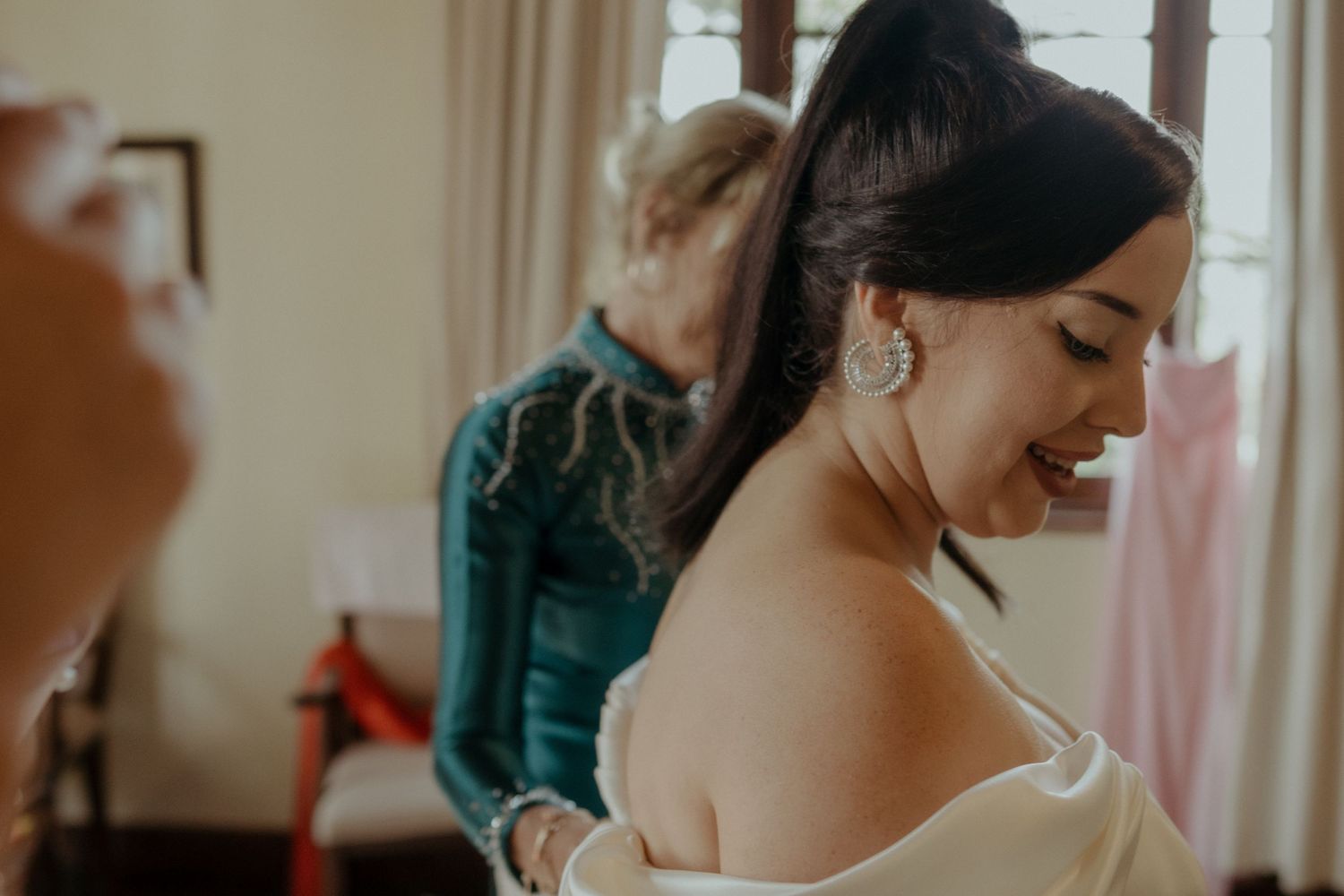 A serene moment during wedding preparations as final details are attended to in a sunlit room.