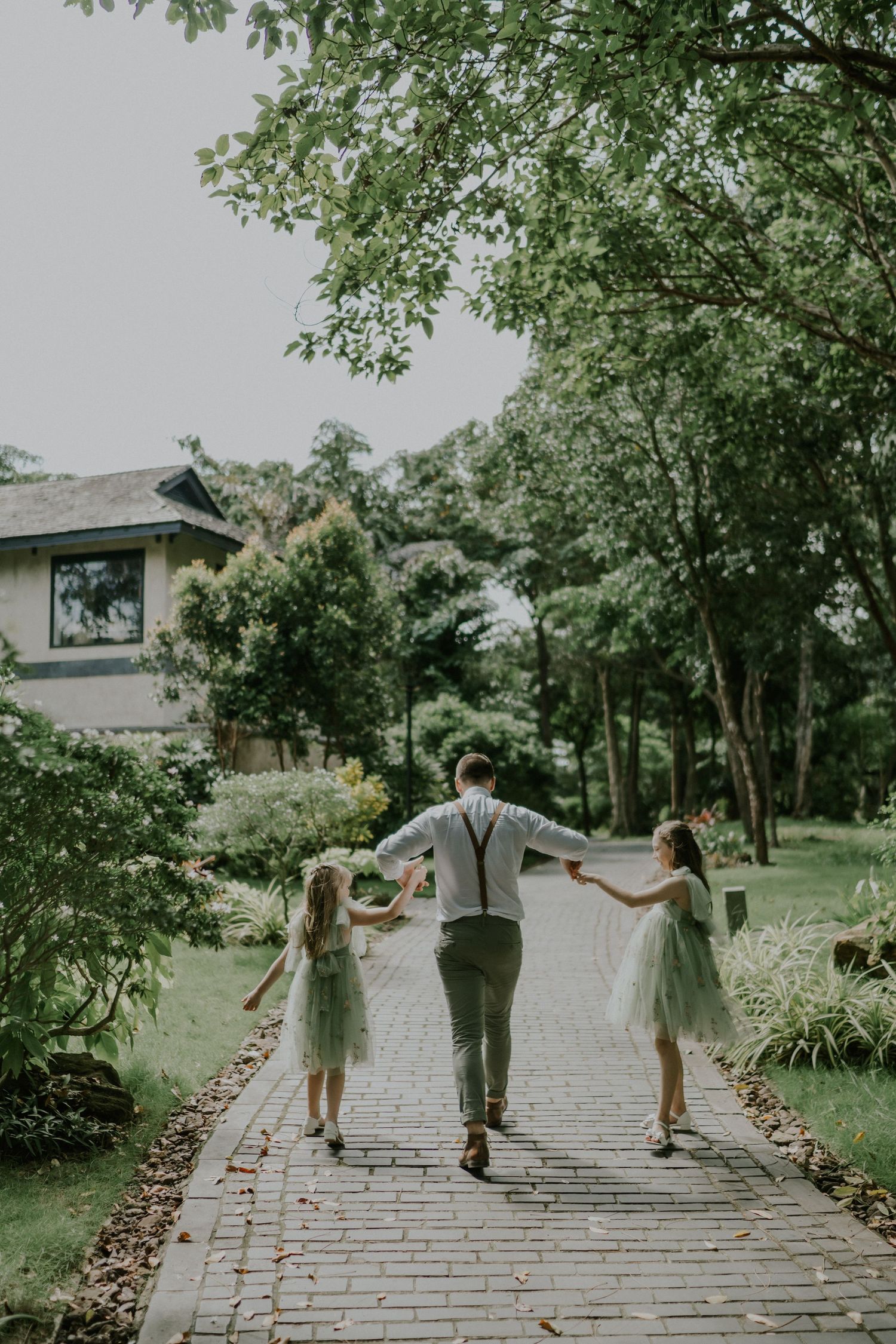 Walking together on a brick path through a lush garden landscape.