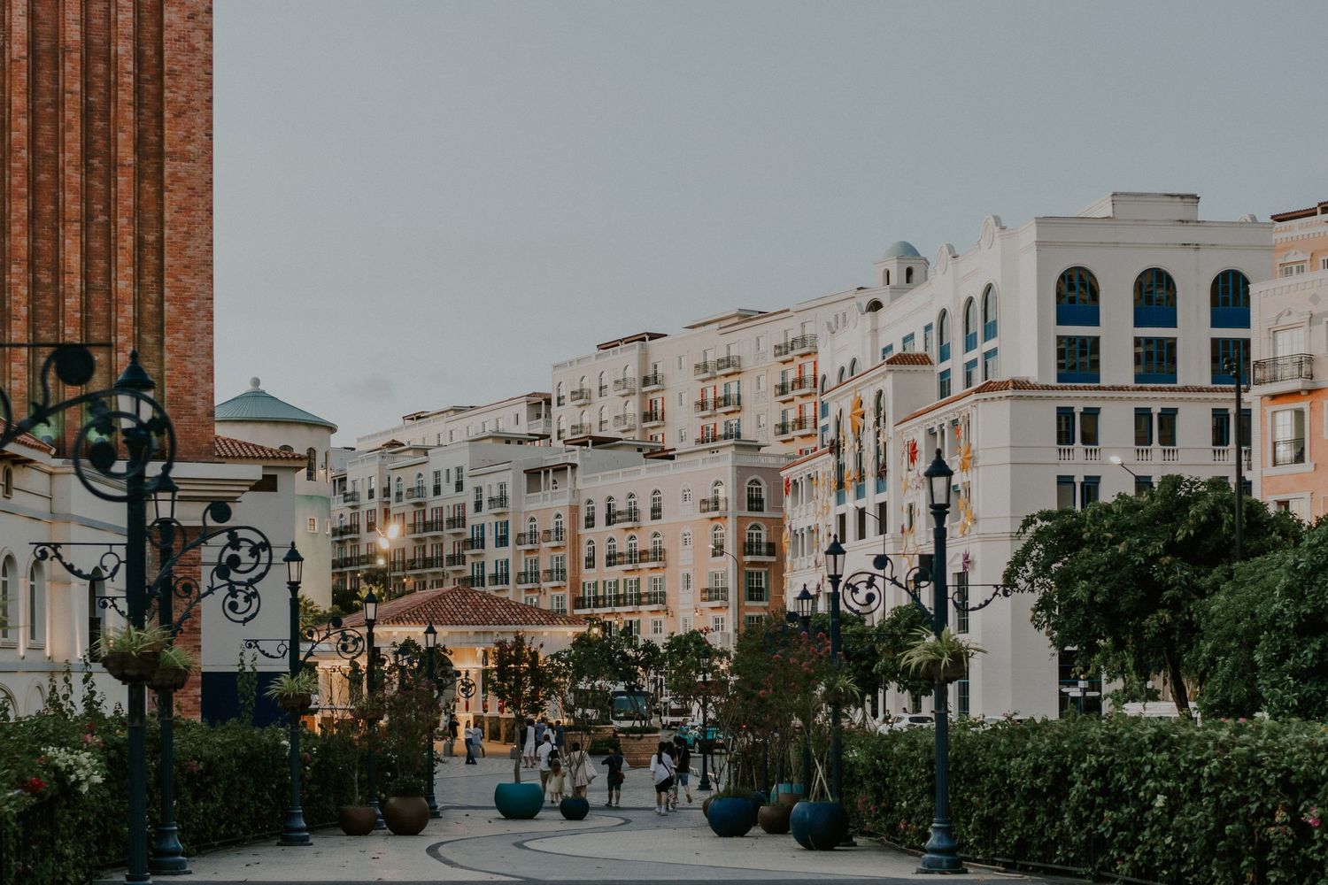 Modern urban streetscape with white buildings and classical European architectural details.