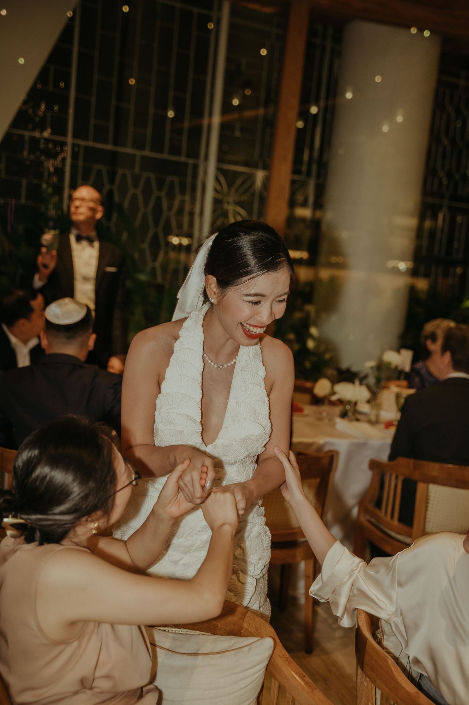 Bride shares emotional moment with wedding guest during reception.