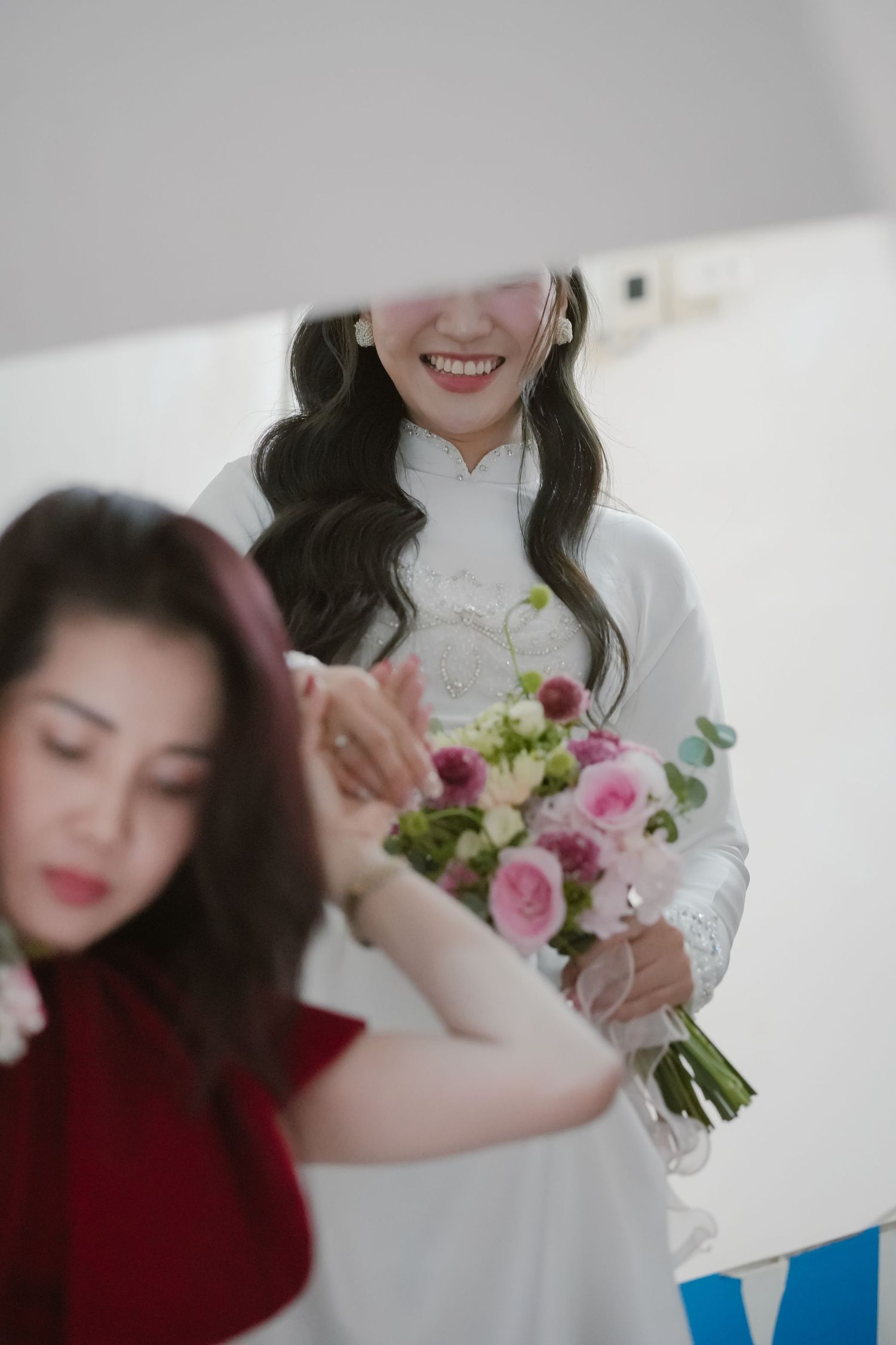 Close-up shot of wedding preparations with pink rose bouquet.