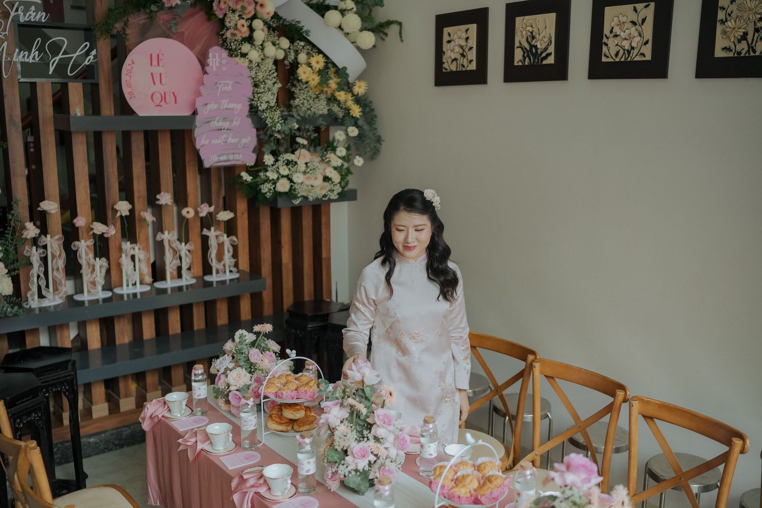 Tea ceremony setup with pink tablecloth and floral decorations.