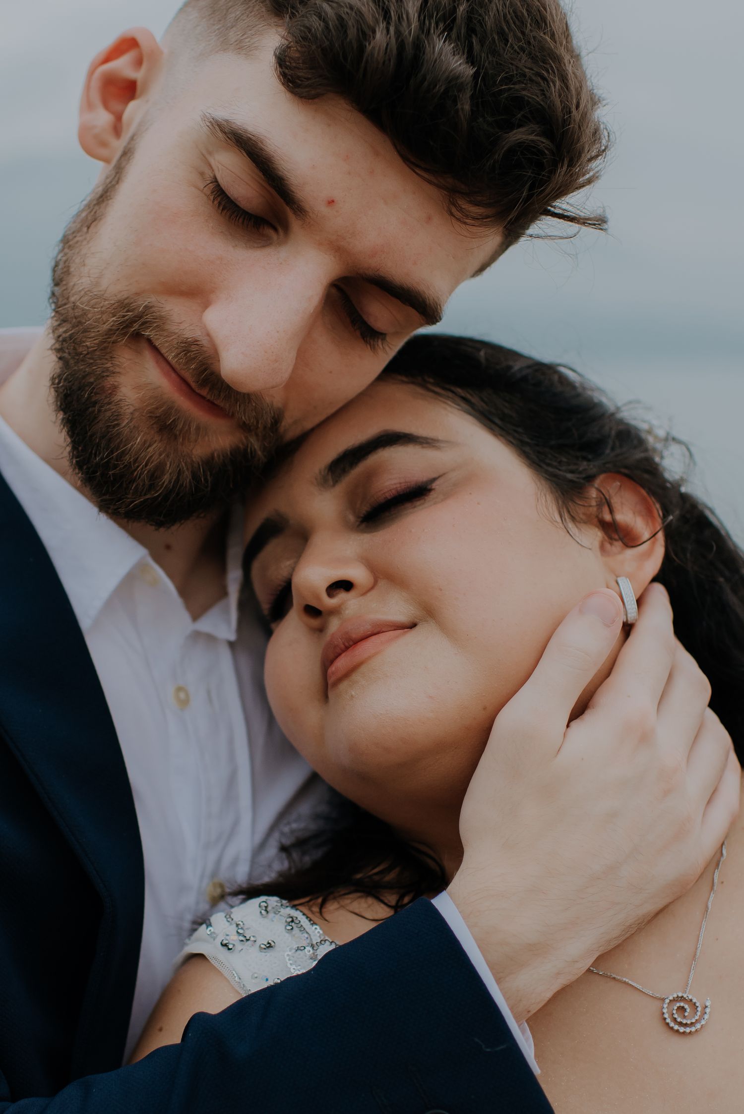 Intimate close-up of a tender embrace between newlyweds.